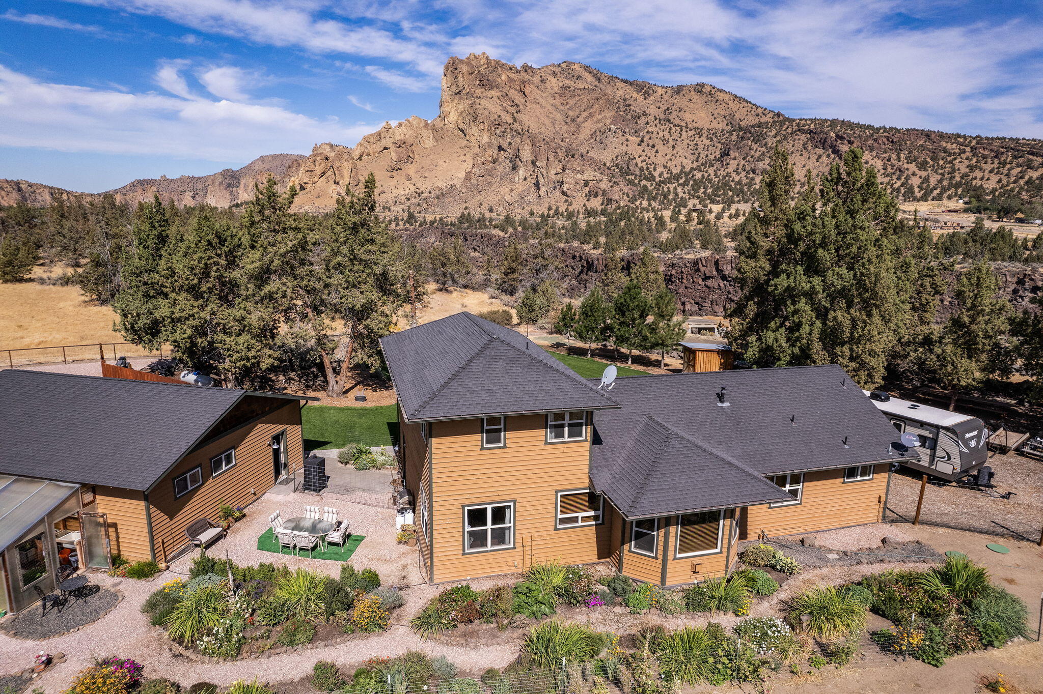 Nestled in a picturesque, park-like setting, this 3bed/2.5bath home offers the perfect blend of tranquility and convenience. Located minutes from the iconic Smith Rock State Park and the Crooked River, this property boasts gorgeous natural scenery right in your backyard. Inside, you'll find a spacious inviting layout, featuring heated floors throughout, providing warmth and luxury during the colder months. The windows flood the home with natural light, showcasing the stunning views. The open living space is perfect for gatherings, while the garden invites peaceful moments outdoors. Enjoy your private & tarp lined pond, lush landscaped grounds, and secure long lasting steel pipe fencing. The thoughtfully designed garden is ideal for relaxation or growing your favorite plants. Whether you're looking for adventure or relaxation, this home offers it all! Don't miss out on the chance to live in this rare gem with unbeatable access to outdoor recreation and peaceful living.
