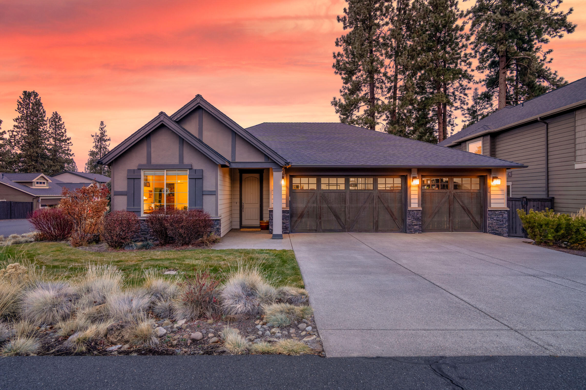 Pride of ownership is evident in this well-appointed 2,092 sq/ft single-level home on a desirable corner lot in Stonegate. Offering 3 bedrooms, 2 bathrooms, and a 3-car garage, this home features an open layout with vaulted ceilings, abundant storage and excellent bedroom separation. The spacious kitchen includes an oversized island, extra-large pantry, and flows seamlessly into the main living area. Large windows fill the home with natural light, while the covered Trex deck extends the living space outdoors. The 3-car garage allows for extra storage and a workspace. Quality finishes include a stacked stone fireplace, solid surface counters, tile showers, stunning cabinetry and millwork, and designer light fixtures. Enjoy the community trail, pool, and playground, with easy access to the highway, shopping, schools, and public land. This wonderful SE Bend property is the complete package for any lifestyle! Front and sideyard landscaping covered by HOA.