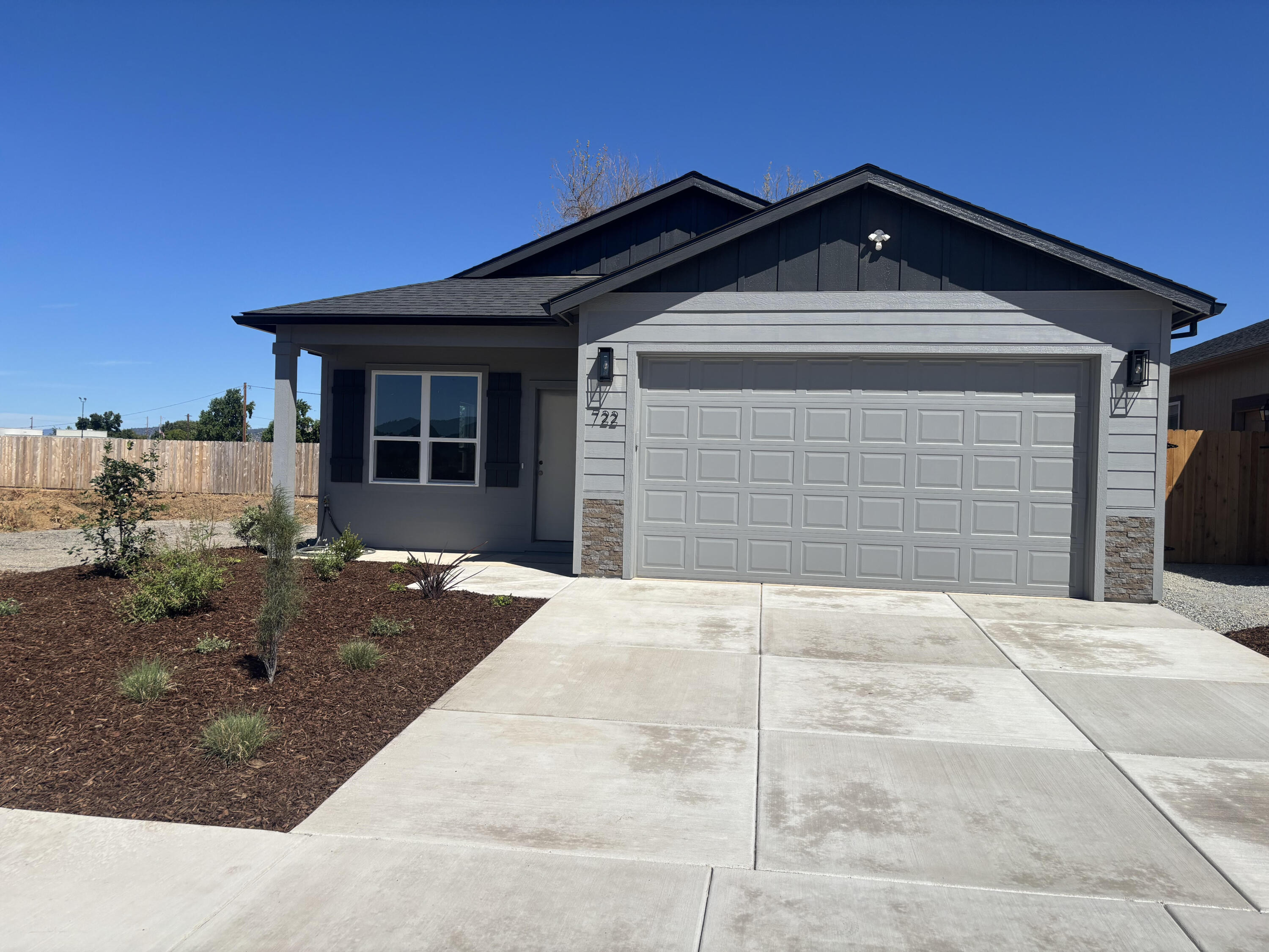 Beautiful new construction home offering 1,404 sq ft, 3bedrooms, and 2 bathrooms, thoughtfully designed with quality finishes and modern upgrades throughout.  The open great room features 9-foot ceilings, creating a spacious and inviting living area.  The  kitchen showcases Gary Smith custom cabinetry with soft-close doors & drawers, granite countertops throughout the home, an undermount farmhouse sink, and stainless appliances, including the refrigerator.  Durable waterproof plank flooring flows through the main living areas, complemented by upgraded light fixtures.  Additional features include a finished garage with opener, covered patio with ceiling fan, and a fully landscaped and fenced yard.  Move-in ready with attention to detail and modern comfort in mind. 
The seller will credit buyers $5,000 to help pay closing and pre-paid cost.
Convenient Medford location near Rogue X Community Sports Complex.