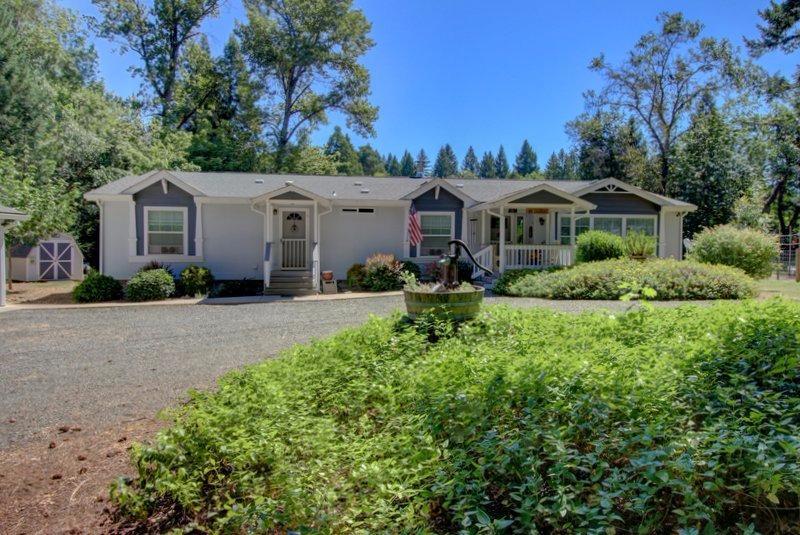 Stunning is the best way to describe this incredible Home. Situated on 4.5 acres with a year round creek in the back of the property. Pasture is below the house level and is very secluded. It is also situated on an Aquafer and is green year round. Great Well that is spring fed. The Fleetwood Barrington is 2693 sf with 2 x 6 interior walls. It has a very open and flowing floor plan with extra large halls and plenty of storage. The kitchen has solid alder wood cabinets and is a cooker delight and great for entertaining. Living room has a real wood fireplace and sits just off the kitchen. Windows throughout brighten the home as if it were in a magazine. The master bedroom is incredibly large and has a big walk-in closet, a master bathroom sure to please, and an office sits off the this same bedroom. 4-car insulated and finished garage, 1120sq.ft. Provides plenty of parking and also a great work area sure to please any hobbiest. There is a lot a covered RV or Boat carport to the s