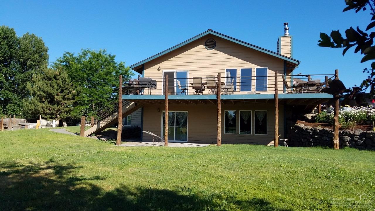 Spacious 5 bedroom, 3 bath home just a few minutes from downtown Prineville. The perfect property for horses, 4-H animals and a variety of other interests and/or hobbies. Windows have had glass replaced, hickory cabinets in the kitchen with granite countertops and heated floors. Daylight basement has 2 of the bedrooms, a nice family area, plumbing for a wet bar and a large storage room that is easily accessible. 30x32 barn, outbuildings, great pasture, irrigation and more. Call for additional information.