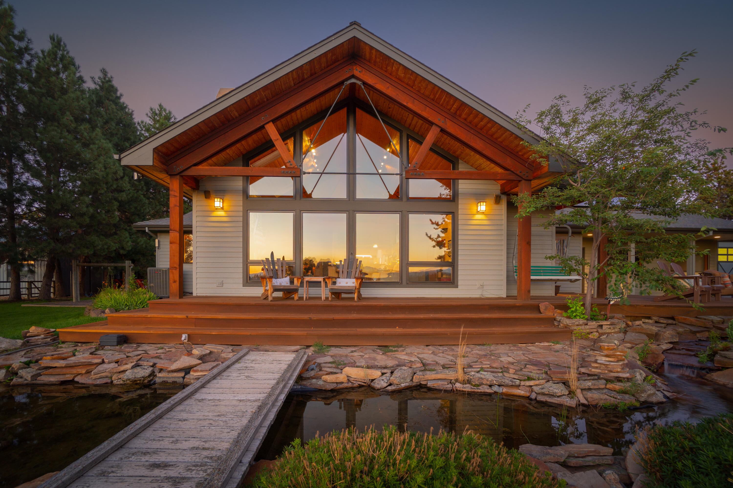 Efficiently designed and lovingly maintained, this nearly 17 acre property offers space, privacy, and an exceptional setting with striking views of the Cascade Range. The main house provides 2,979 sq ft of warmth, light, and a sense of home - bringing the outside in with oak floors, stone flooring, natural wood ceiling, wood burning fireplace, and expansive west windows. An open format kitchen, dining, and living space allows for dynamic entertaining and connectivity for family and guests. A private primary suite, two additional bedrooms, a guest room or den, and charming home office complete the home. An additional detached garage allows for multiple vehicles and storage along with a home gym, and the barn and workshop offers abundant space for hobbies. Horses or livestock are welcome in the fully fenced pasture complete with electric fencing, loafing shed, and stall barn. Two solar systems, 14 acres of COI irrigation, and so much more, make this a fantastic opportunity.