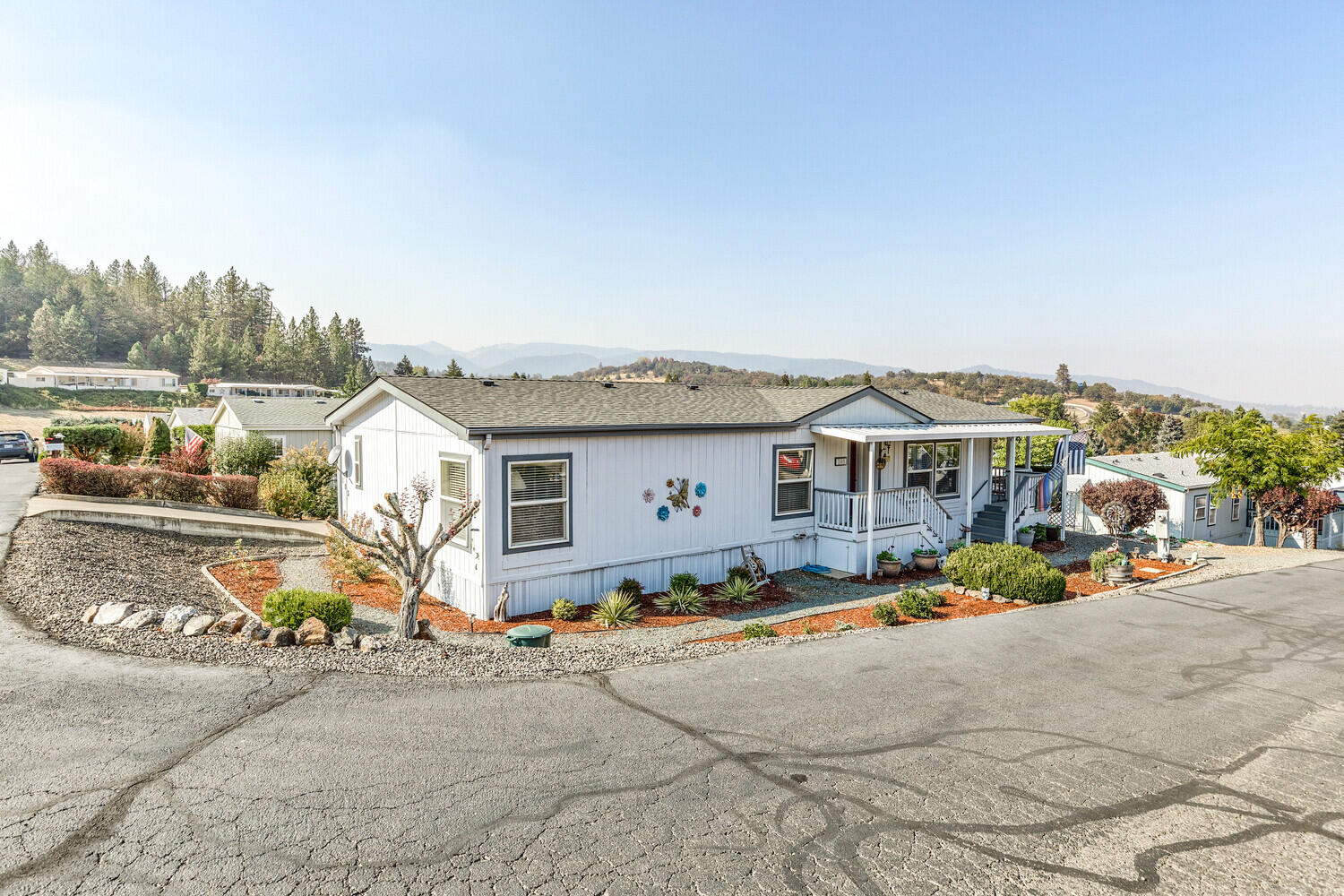Seller motivated! Amazing Views in this Mobile Home located in the Western Carriage Estates.  Built in 1995, this home has been completely updated.  Kitchen with granite counter tops, lots of nice cabinetry, tile & laminate flooring; new dishwasher & water heater. Nice sized master suite.  Washer & dryer also included. There is also a newer roof, a carport, and a storage shed. Relax on the porch, while watching the amazing views.  This home is move-in-ready!
