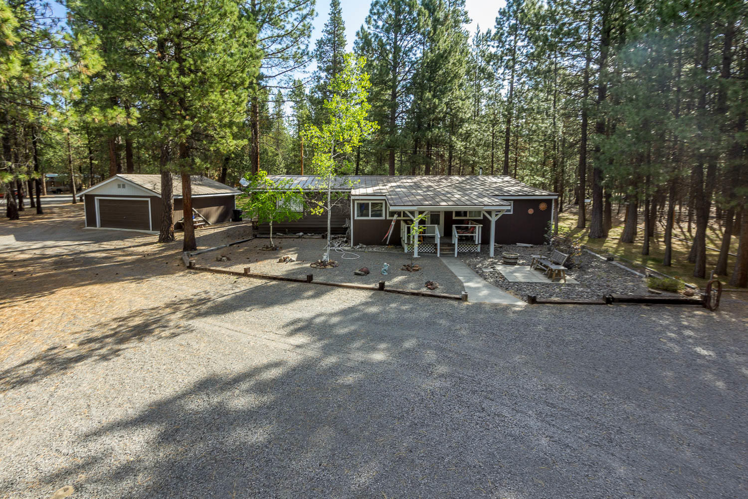 Well cared for home!  Nice floor plan. Large family room, living room, dining room, separate breakfast nook. One master suite, the other bedroom has direct access to the guest bathroom. Huge storage room or can be used as a craft room just off the breakfast nook area.  Completely fenced! Small fenced in area in the back for a dog.  The property has many matured Ponderosa Pine trees.  Detached double garage, storage shed, workshop, small greenhouse attached to workshop, RV cover, storage shed for wood. All nicely laid out for easy access.  Call to preview today!
