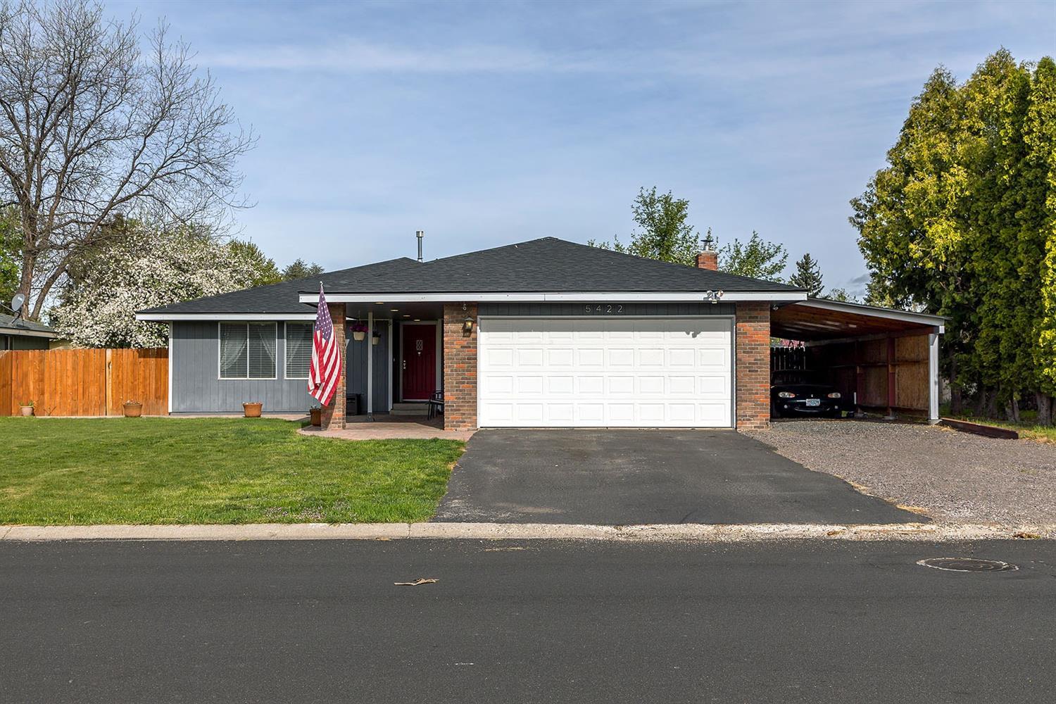 This Gatewood home has been updated with many nice features like the covered entry way that has pavers and custom recessed can lighting. The open floor plan has a private sunken living area to the left of the entry way. The kitchen, dinning and family room area are open and there is a certified wood stove/fireplace in the family room. Custom recessed can lighting has been installed inside the home which provides great lighting. The laminate floors and carpet are recent. The front parking area has plenty of room for most RV's and there is a two car attached garage with a 11' x 34' carport plus another 13' x 36' uncovered parking area to the side of the 16' x 33 driveway. There is a 10' x 12' shed and a 10' x 14' deck in the back yard. There is an apple tree in the back yard.