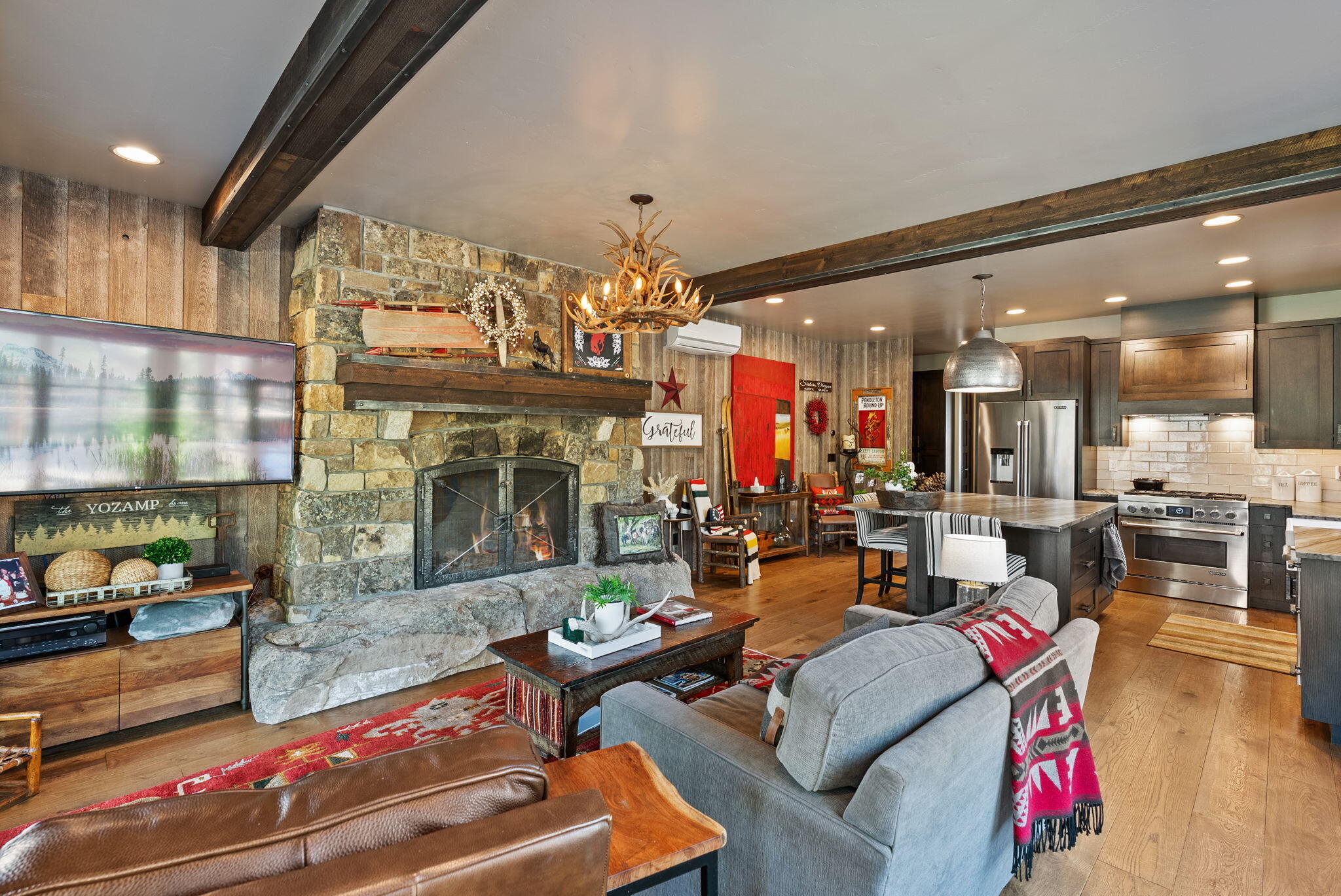 Designed for the luxury RV enthusiast, this custom-built home with a fully outfitted, heated shop is also the perfect second home or snowbird retreat. The efficient floorplan delivers high-end comfort with hand-selected white oak cabinetry, a chef's kitchen with quartzite countertops and built-ins, a wood-burning fireplace, and a spa-style tiled walk-in shower. The radiant in-floor heating throughout adds year-round warmth and efficiency. The shop is RV-ready with septic, 50-amp power, dedicated 30-amp lift circuits, water, and custom metal cabinetry. Exterior features include quarter-sawn cedar siding, steel accents, a premium tile roof, full landscaping with irrigation and lighting, plus a matching custom shed. Gated, fenced, and ready for future expansion.