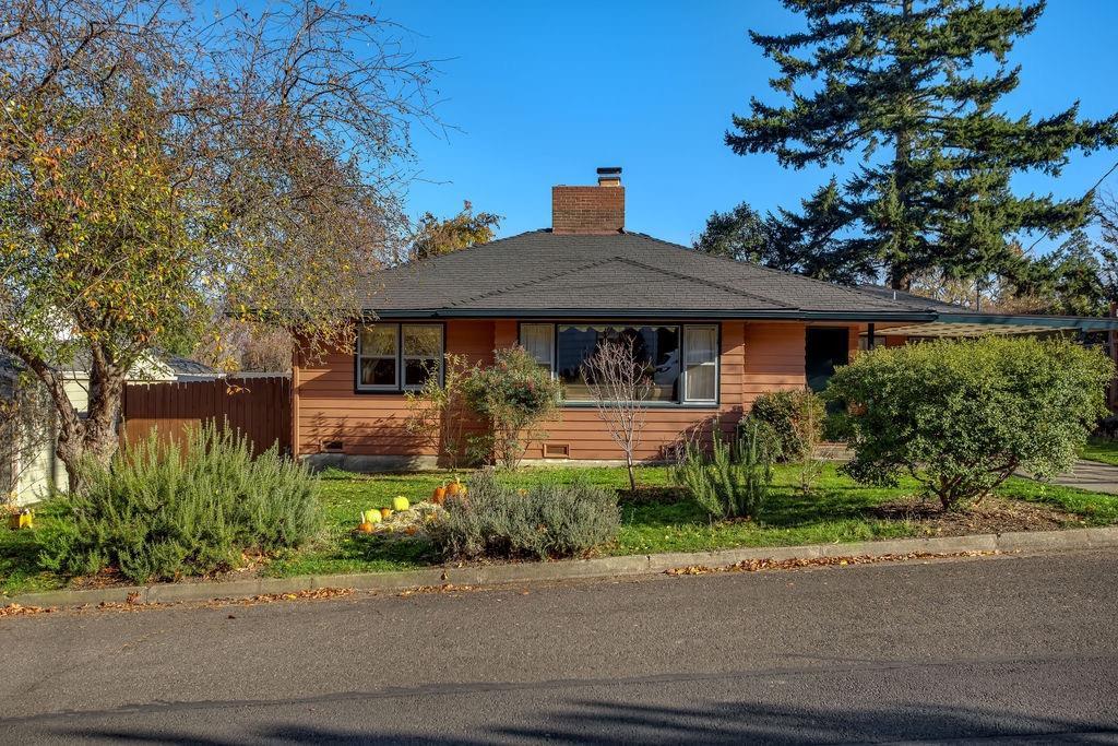 Charming 3 bedroom, 2 bathroom 1950's home on a quiet, lovely street above the boulevard. Close to schools, shopping and pretty Garden Way Park which includes a kid's play structure area and community garden. The warm and cozy home features hardwood floors throughout and has a beautiful picture window in the living room with fireplace. Renovated kitchen with beautiful wood cabinets and farm style sink. Extra attached living space which could be used for guests and has new flooring in the bathroom. Vast permaculture backyard offers a wide variety of plants and flowers with plenty of room for gardening (see attached list with numerous types of vegetation etc.) and includes a storage shed. Come experience this great home with commanding views of the mountains!