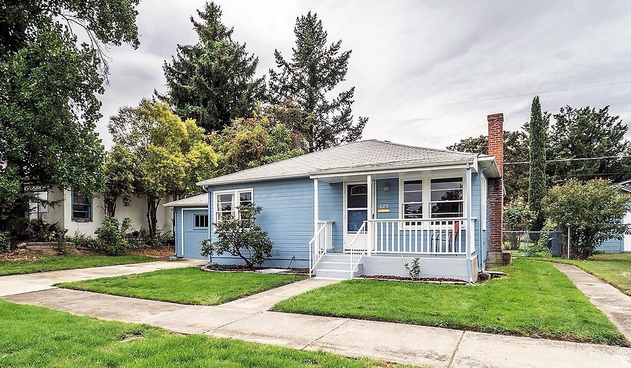 Adorable cottage with 2 bedrooms and a bonus room. Newly refinished hardwood floors, recently painted interior, lots of windows, fireplace. New sink, faucet, toilet and flooring in bath. New sink & faucet kitchen. Attached single car garage with alley access, covered patio, fenced backyard, automatic sprinklers, 3 rain water catchment barrels. Large utility room, bonus room perfect for office or hobby room. Forced air gas furnace. Conveniently located close to downtown and shopping.