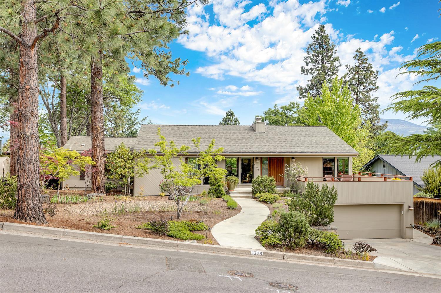 In 2007 this home underwent a complete transformation by Benchmark Builders. Kitchen was highly customized with pull-out pantries, large island, skylights, vaulted ceilings, Thermador/KitchenAid appliances, and is open to dining. Wood-burning FP in dining, gas FP in living. 2-car garage was cleverly added under new front decking. New rear decking is accessed from both LR and master. Both baths completely redone, new sliders and French doors. Complete new HVAC in 2012, new vinyl windows about 4 years ago, newer Hunter Douglas blinds throughout. Landscaping totally redone w/ automated lighting, hot tub, raised beds, pergolas and plantings; backyard is private and deer-proofed. Lower level includes 2 bed, 1 bath, storage/wine cellar, workshop, garage and light and bright laundry w/access to backyard. New architectural comp roof + insulation added in 2010. Other features include whole house fan & 2 sets of Phantom screens, solid oak floors.