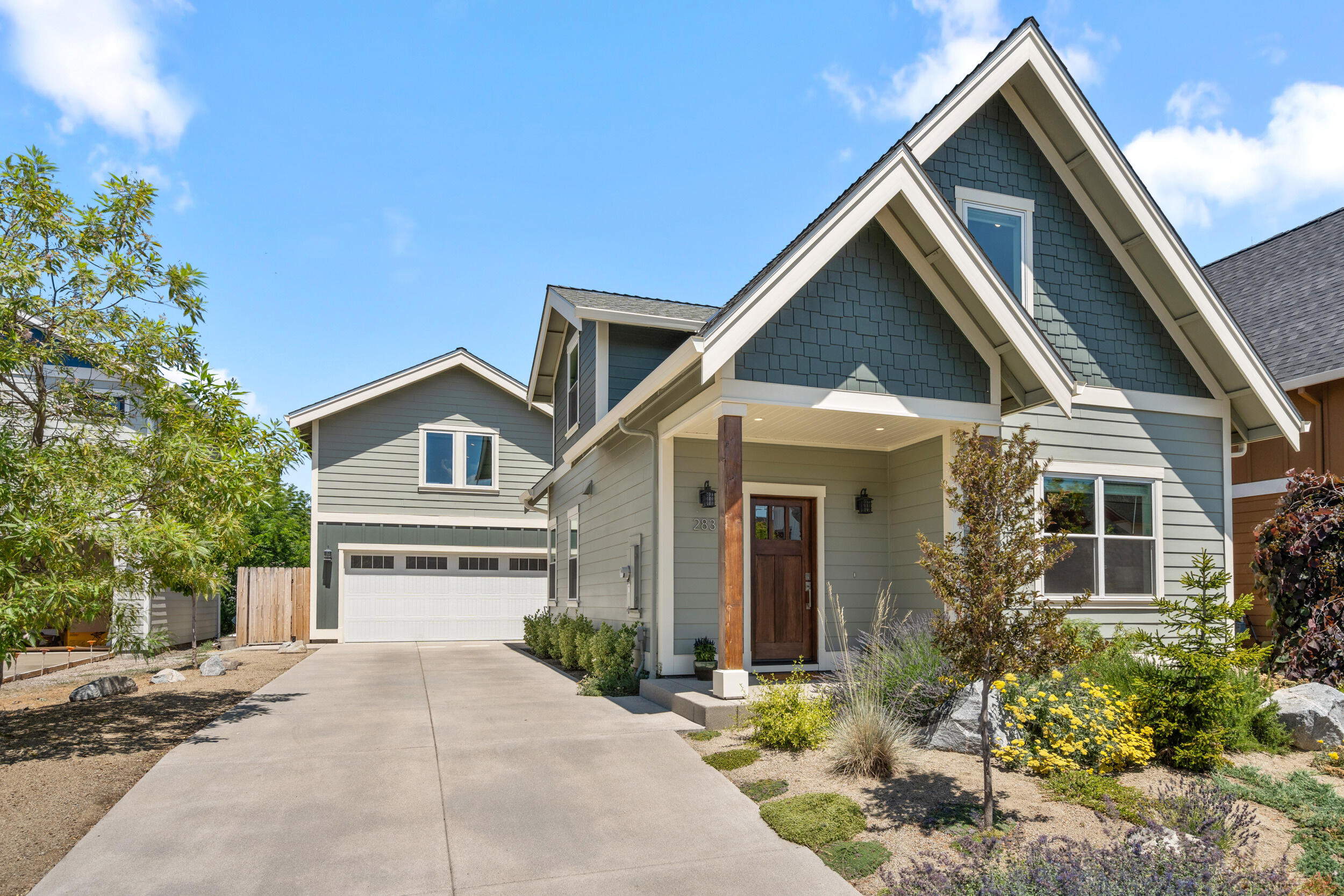 Located in sought-after Old Bridge Village, this 2021-built home with legal ADU offers quality, comfort, and efficiency. The 1,636 sqft main house features 3 beds, 2.5 baths, vaulted ceilings, and an open floor plan with white oak hardwoods, solid core doors, and premium fixtures. Enjoy a bright and airy living space with a stylish kitchen featuring quartz counters, breakfast bar, gas range with hood, and top-tier appliances. The main-level primary suite includes French doors to the patio, walk-in closet, and spa-like bath with tiled shower and heated floors. Above the 2-car climate controlled garage, the 546-sqft ADU provides great flexibility and opportunity for additional income, featuring a full bathroom and kitchen with pantry. Private backyard with BBQ/fire pit stub, ductless mini-split system, and beautiful mountain views—all in a quiet, no-HOA location. Very close to downtown Talent.