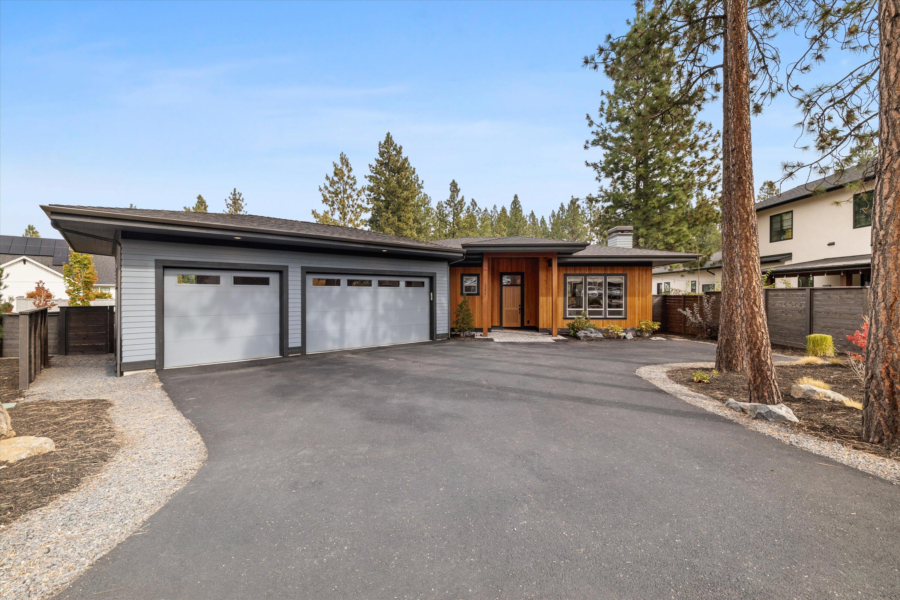 Beautiful, almost new, builder's own home in popular westside neighborhood, Shevlin Ridge. This single level modern prairie style home sits on a large, flat, .24 acre corner lot. Large windows throughout make this home light, bright and inviting. Features an open, great room floor plan with large kitchen, professional grade stainless steel appliances including refrigerator, double door pantry, quartz countertops. Wood floors in living room, dining, kitchen and hallways. Dining area opens to a large covered paver patio that is both private and sheltered. Large 2nd and 3rd bedrooms with walk-in closets. Large Primary Bedroom suite with huge walk-in closet, dual vanity, and large tiled shower. Three car garage with plenty of additional space for shop or storage. Close to the trails and open areas of Shevlin Park. No HOA fees.