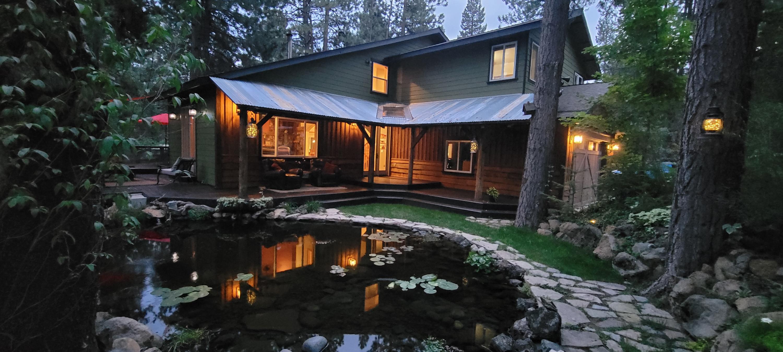 Stunning, updated 4 bd/3.5 ba custom-designed retreat! Enchanting setting w/Waterfall & pond on 1 acre in serene Valley Ridge Acres! Private boat launch to River, backs to Forest/Trails! 2 En suites! Spacious qtrs, roomy closets! Finished Basement for private, addl living qtrs/woodstove, Game Rm, galley kitchen or office area. Multiple decks for outdoor entertaining. Heated Shop/Office & 12 x16 corral at the back of the lot. Sunroom. Fresh ext/int paint. Kitchen w/copper accents, new stainless appl. w/upgraded range hood, Hickory cabinets & slide out shelving. Hammered Copper farm sink. Granite & Soapstone counters/tiled backsplashes. Center island & Oak hardwood floors in kitchen & dining rm. Venetian plaster. 18 ft ceiling in Living rm, French doors. New LVP flooring. Tile flooring in entry, baths. Dual vanities, jetted tub.  Central Vac, Heat pump w/electric air filters. Hot tub overlooks the private gardens, Fire pit. Two outbldgs/4 bays in back for all your toys, tools & storage!