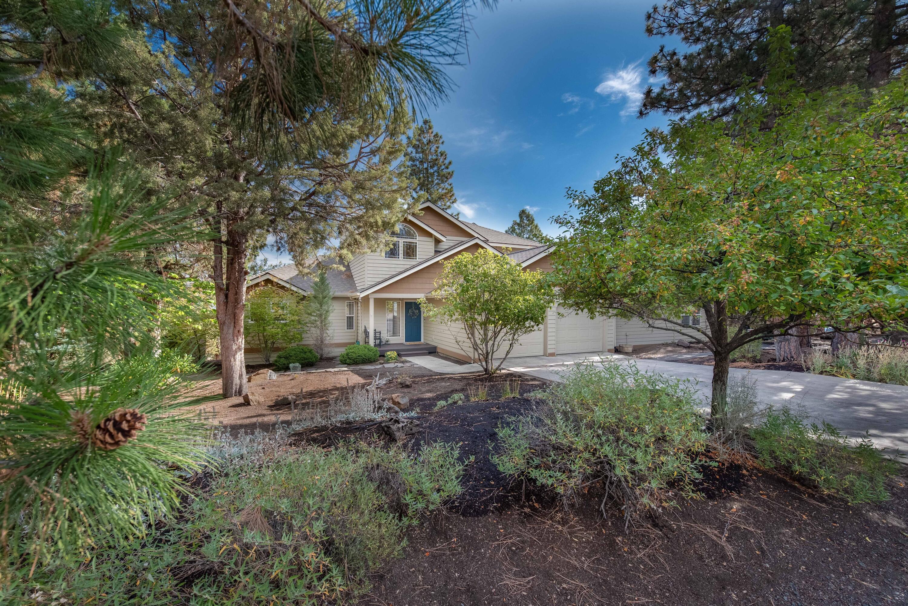 This beautiful light filled home in NW Bend sits on a large, half acre lot that adjoins the neighborhood open space, providing access to the popular Deschutes River Trail. As you enter the home, you are greeted with vaulted ceilings and a wall of windows showcasing amazing easterly views. The kitchen is perfect for cooking and entertaining with beautiful custom wood cabinetry, two drawer dishwashers, a built in refrigerator, a walk in pantry with plenty of storage. The primary bedroom and spa-like bathroom are on the main floor with easy access to the hot tub on the back deck where you can soak up the twinkling city lights on chilly evenings. Upstairs there is a nice loft area/flex space for a home office or workout area and two guest bedrooms with a shared bathroom between them. The 4th bedroom and bathroom are in the attached, permitted ADU on the main level. Come see this beautiful home in NW Bend today!