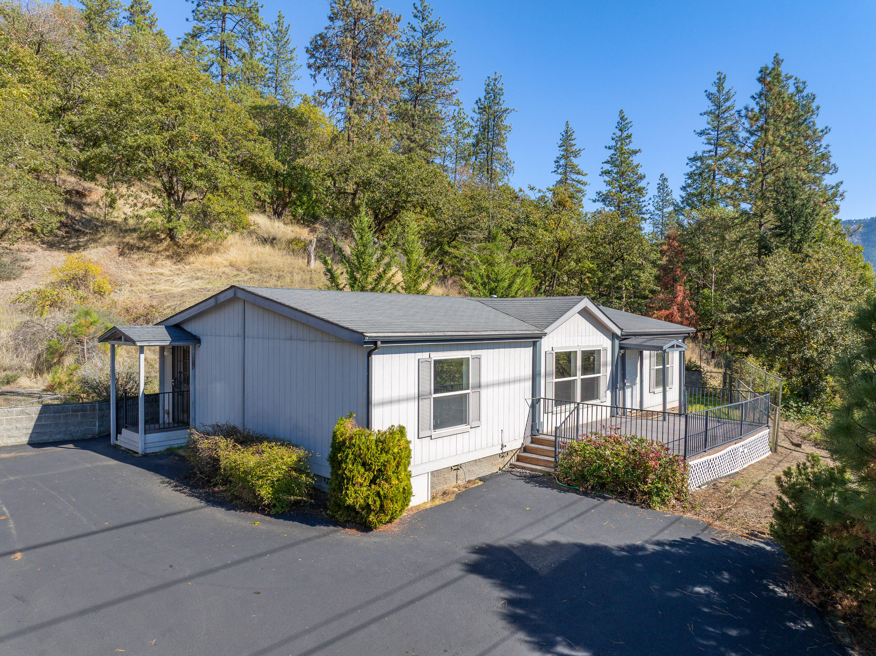 Enjoy peaceful country living with phenomenal views of the Applegate River and the surrounding mountain range. This 3-bedroom, 2-bath manufactured home offers 1,296 square feet of comfortable living space on a private .81-acre lot. The open layout provides plenty of natural light and easy flow between living, dining, and kitchen areas. The primary suite includes a spacious ensuite bath, and the additional bedrooms are perfect for guests, office, or hobbies. Outside, relax on the deck and take in the incredible scenery or explore the nearby vineyards and outdoor recreation the Applegate Valley is known for. Ample parking, mature trees, and room for a garden make this property feel like home. Bonus: the property qualifies for an assumable VA loan, offering an excellent financing opportunity for qualified buyers. And is also USDA Eligible!