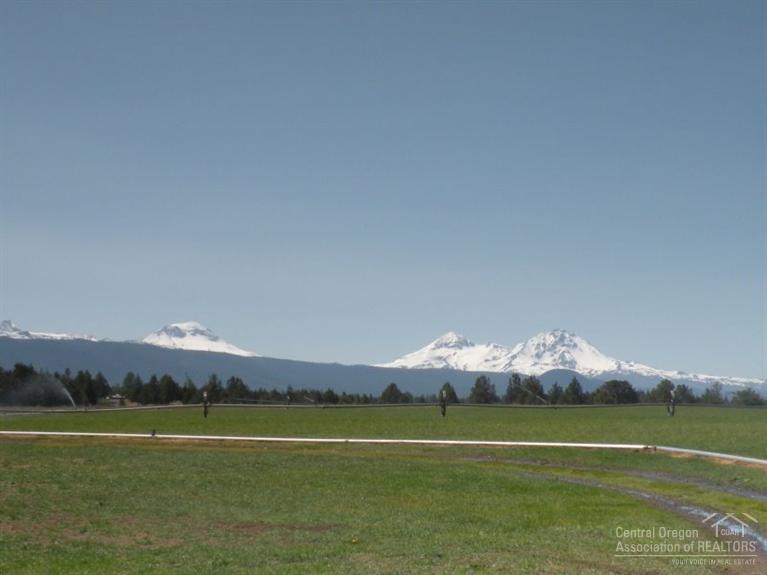 A rare opportunity to own a special 100 acre Tumalo property. This Cascade Mtn view property consists of 3 legal lots: a vacant 40 acre parcel, a vacant 20 acre parcel, & a 40 acre parcel with a 3 bedroom 2 bath manufactured home & a large shop w/ guest quarters. Each parcel has irrigation water rights & each offers unique terrain features. The shop provides a lot of room for your farm equipment, toys & hobbies while the home offers a comfortable place to live while you build your dream home.