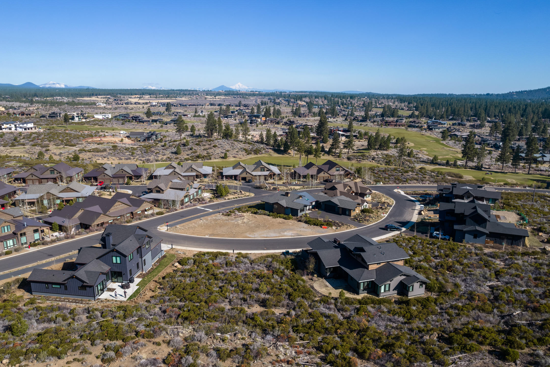 Build your dream home on one of the last remaining lots in award winning Tetherow Resort. This flat .21acre lot is situated above the road offering a lifetime of protected panoramic views, while also backed up to a beautiful rock outcropping. Alpine Park and common area for guaranteed privacy. Tetherow offers world class golfing, three on site restaurants, miles of walking and biking trails, fitness center, pool, and easy access to Mt. Bachelor ski resort, cascade lakes and all that Bend has to offer. This is a must see and won't last long!