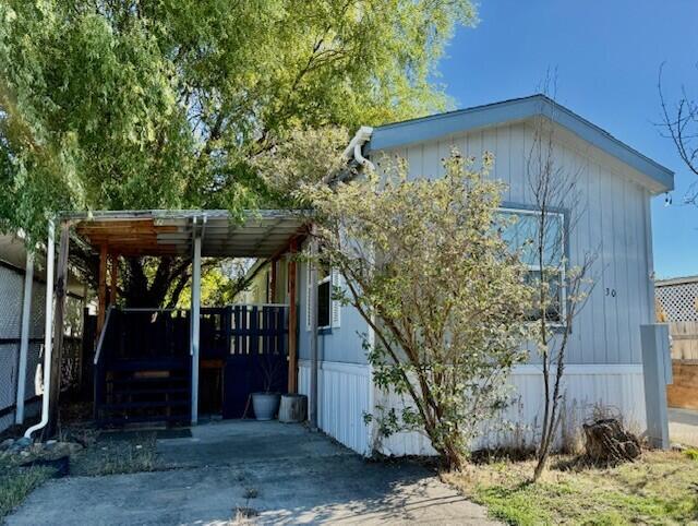 Welcome home to this cute mobile home! This 2013 2 bedroom/1 bathroom home sits on a nice fully fenced lot with a large yard and trees for shade and a firepit to enjoy some outdoor time in the chilly weather.  Inside the home is very clean.  Floorplan is open from the living room to the kitchen which has nice wood cabinets.  There's laminate flooring throughout the living room and kitchen. Outside you'll find two sheds and a workshop.