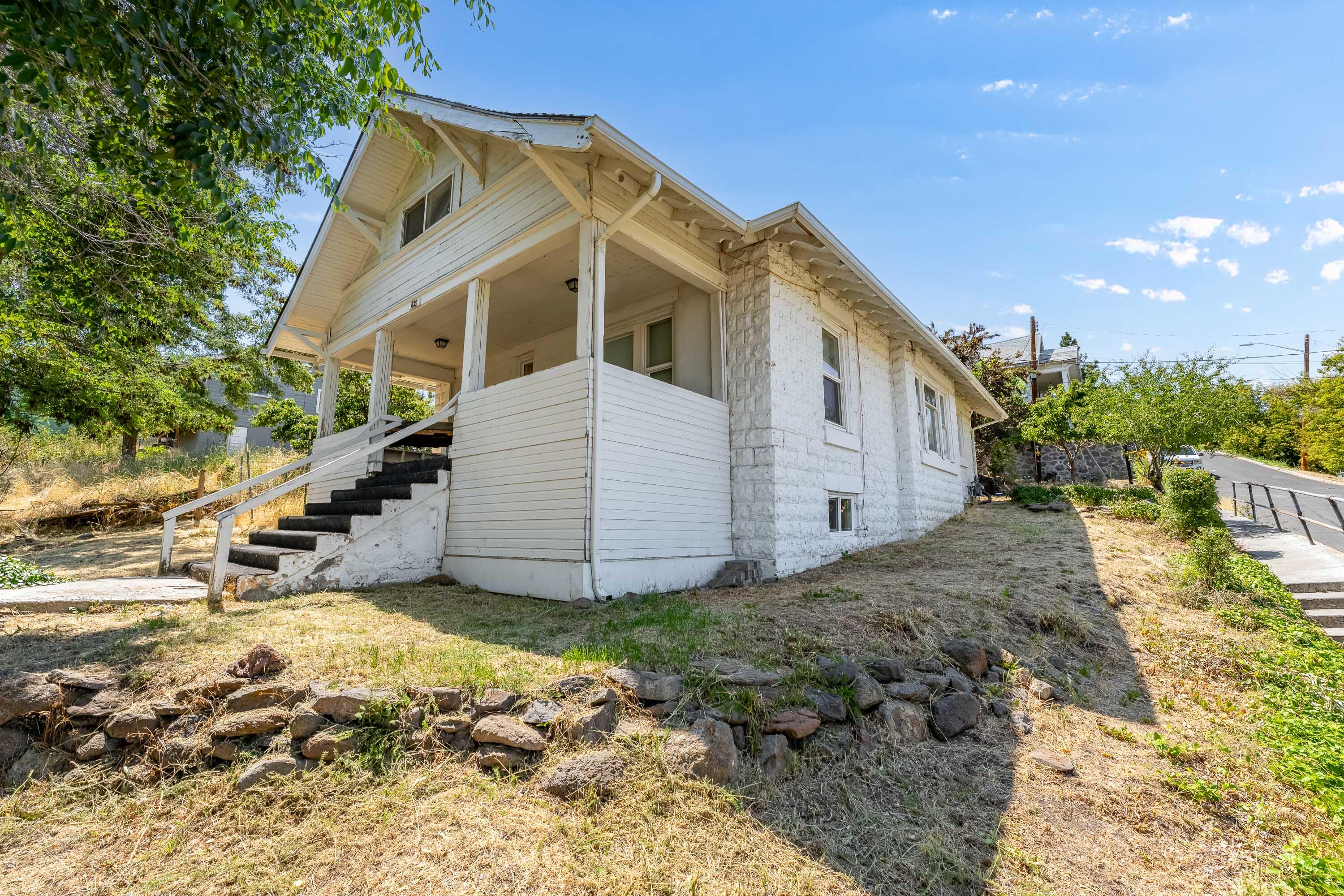 Charming two story craftsman style home nestled in the heart of Klamath Falls. This home offers 1,757 SQ FT of living space with 3 bedrooms, and 2 1/2 bathrooms. The basement offers additional square footage, great for storage or a home gym. Home sits on a .13 acre corner lot. Detached 2 car garage/carport. Enjoy beautiful views of the City of Klamath Falls from your own covered front porch. Move in ready interior! Updated vinyl windows. While the exterior of the home and property could benefit from a little TLC, this property holds great potential for anyone looking to buy. Located just minutes from downtown, this home offers the perfect blend of city convenience and scenic surroundings. Whether you're a first-time buyer, investor, or someone seeking a home with historic charm, this one is worth a look. Less than 10 minutes to Klamath Lake, Oregon Institute of Technology, and most of the amenities of town.