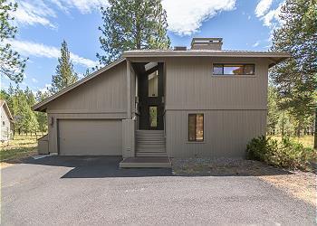 Location, Location, Location. This home sets on a .16 acre lot looking out to the mature ponderosa pine trees and a large open common area. This home features 3 full suite, one on the main reverse great room living area and two downstairs off the living room. This home offer 2 living areas both with large decks. The reverse living area has a newer rock surround fireplace with vaulted ceilings and a wall of windows looking over the large deck and out to the common area. The downstairs living area has a sliding door out to the large deck and hot tub. Come take a look at what this home has to offer.