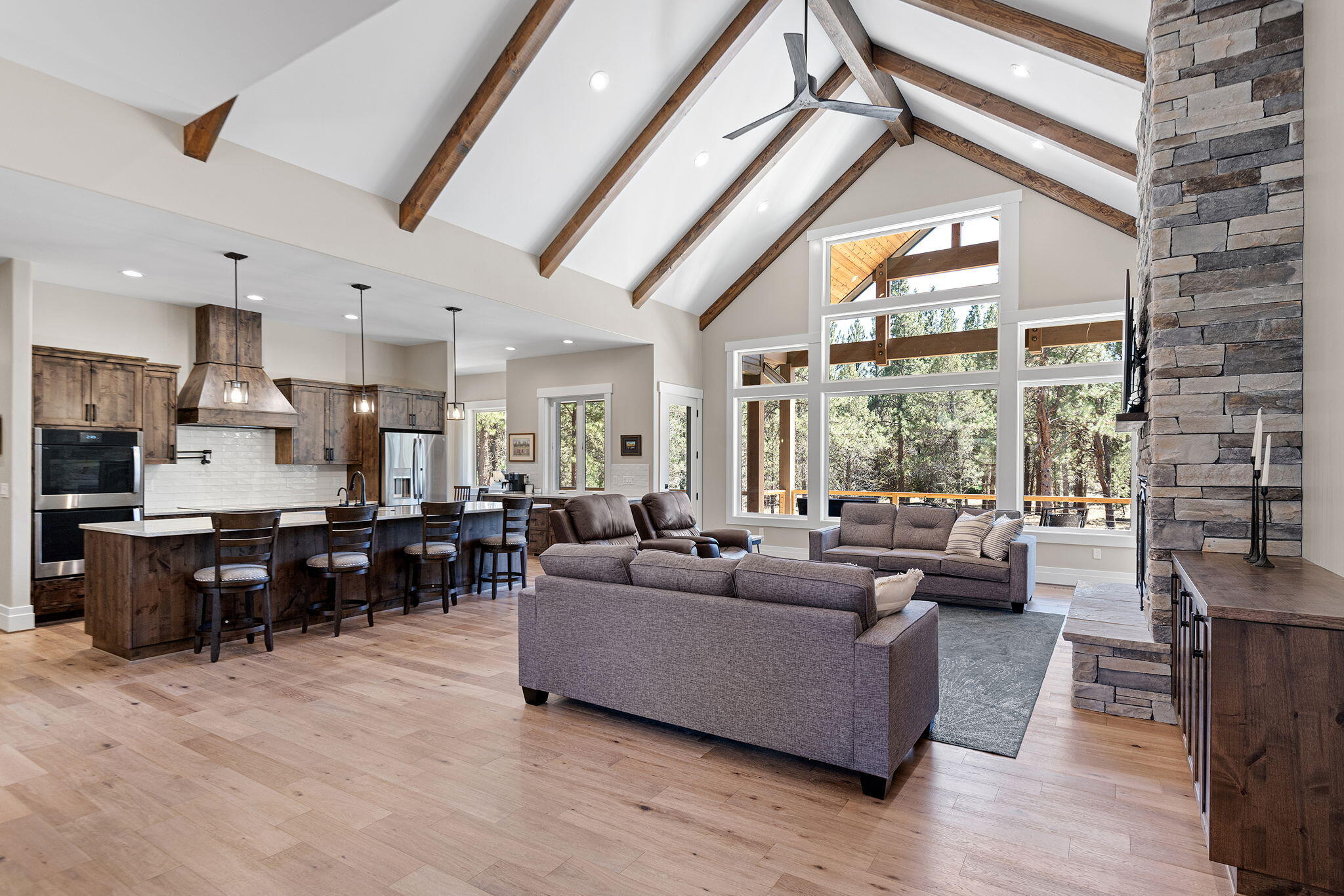 ''Bringing the Outside In'', this lovely home in the gated community of Aspen Lakes is a fusion of northwest and contemporary architecture. Vaulted/beamed ceilings, oversized windows, dry stack stone fireplace and custom luxury finishes. The dream kitchen has multiple workstations, quartzite counters, pot filler, induction cooktop, double ovens, walk-in pantry and generous island with seating. Both the breakfast nook and spacious, separate dining await you and your guests. This 3,170 sq ft home, which sits on a 1.25 acre lot boasts its own automatic backup generator. A paved circular drive brings you to a nicely landscaped front entry. Enjoy the back deck with built-in grill, forest view and a hot tub. The primary suite is luxuriously separated and feels spa like. In addition to 3 spacious guest rooms, with designated full bath, there is a half-bath, office/den and huge bonus room currently used as a sewing studio. Extensive storage space above the 2 car garage and EV Charing outlet