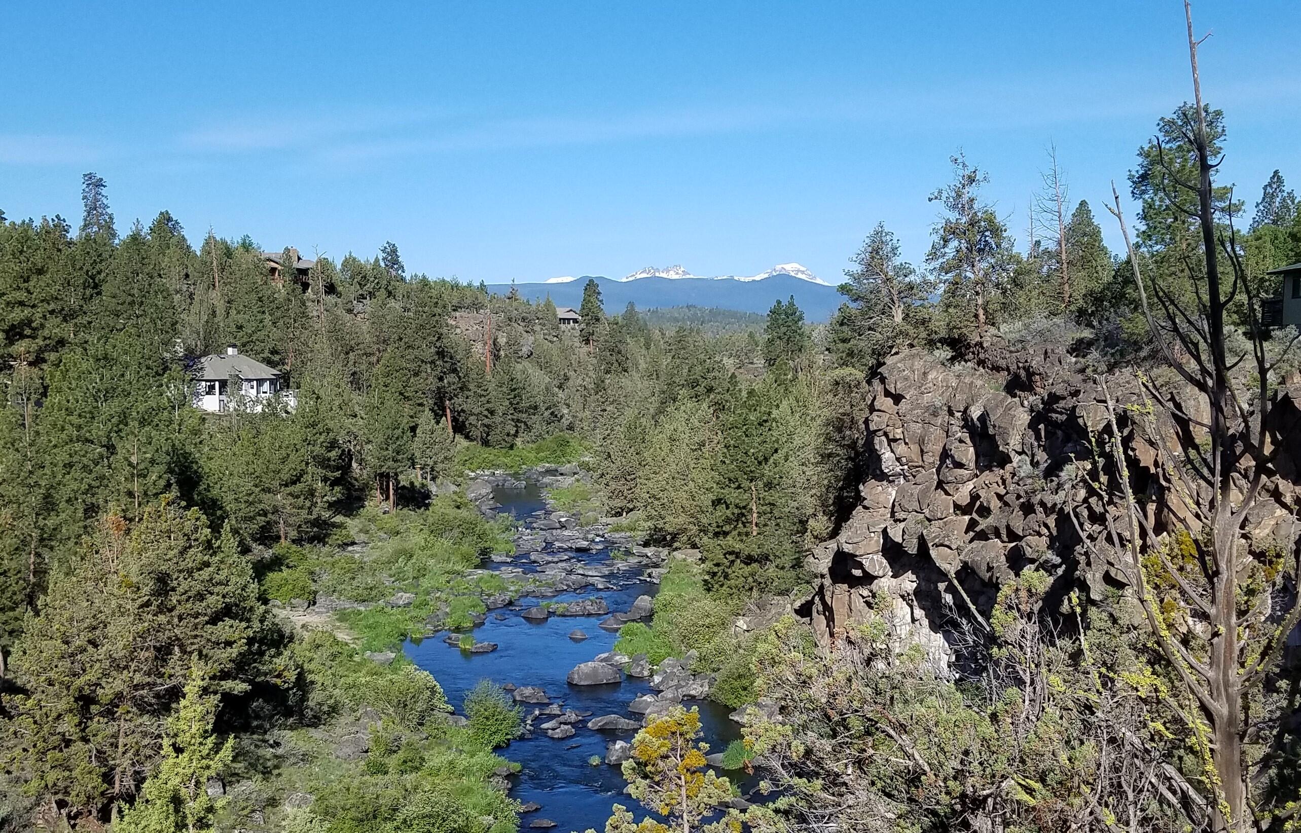 This home has one of the most beautiful views of the river and mountains!  Enjoy the beauty and the peace and quiet while relaxing on the deck.  It seems like you're miles away , but you're really so close to town. This home boasts vaulted ceilings and floor to ceiling windows to take in the view.  Open kitchen, dining and living room makes it an easy home for entertaining.   Bedrooms are both downstairs.   Off the primary bedroom is an office/nursery/craft room, which then leads to a beautiful outdoor entertainment area.   Bathrooms and kitchen have all been remodeled.
There is a very nice storage shed with electricity.   Next to the garage is a carport area for a 3rd vehicle or boat, with lots of storage for all your toys.
21 new solar panels generate electric power to reduce the electric bill significantly.
Septic was totally redone in September 2024.  New decks on lower level.