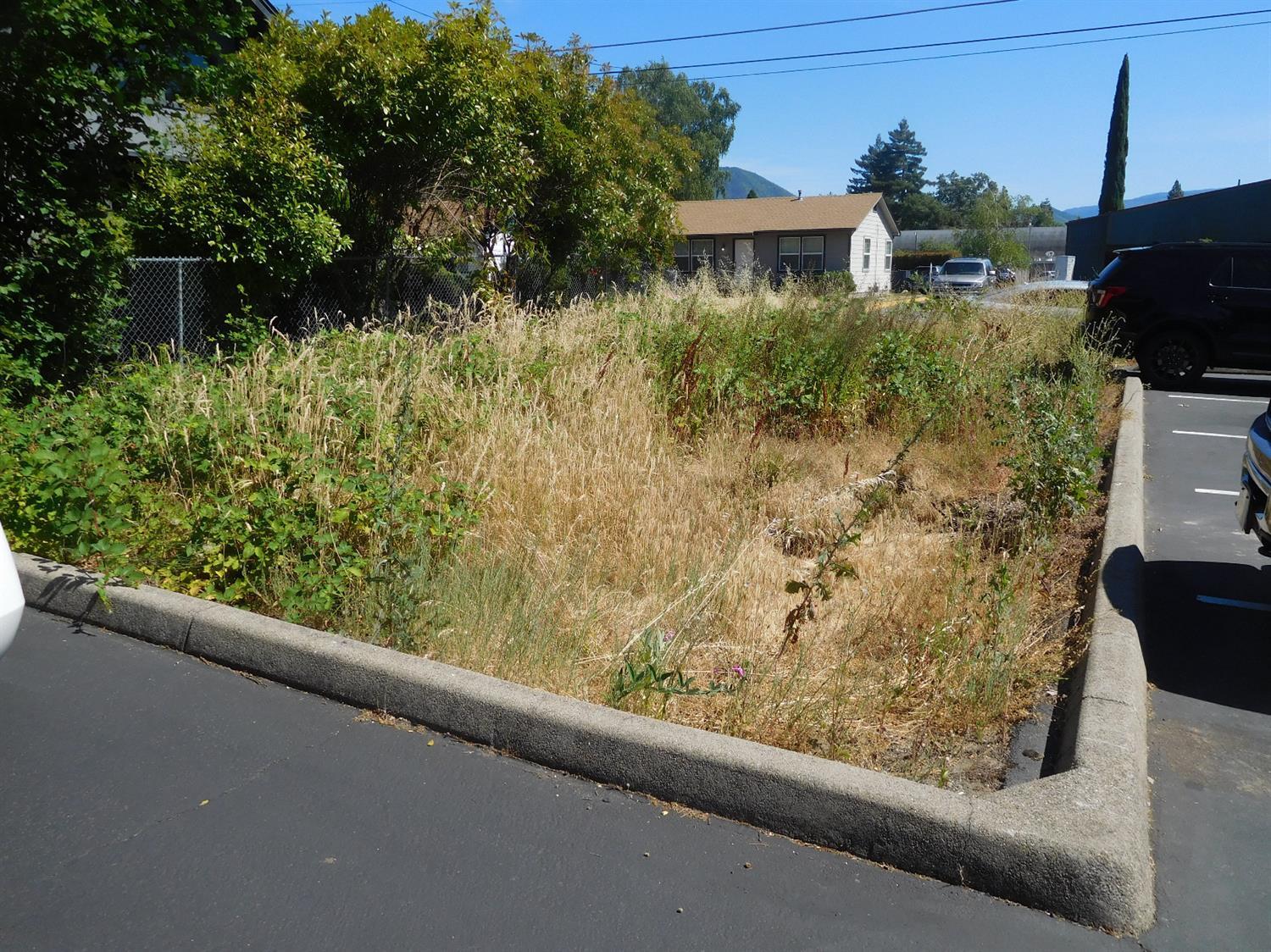 Not too many smaller commercial lots available in this area. Level lot, has already approved initial bldg plan(including the engineering), parking and landscaping. Shared paved access onto parking lot. Plans are for initial proposed use, will need altering if necessary for your own specific floor plan/use. Short distance to major traffic flow (7th street) and yet not on a heavily traveled street. Bring your ideas and business desires. Buyer to conduct their own due diligence with City of Grants Pass or any other regulatory agency regarding uses of the property.