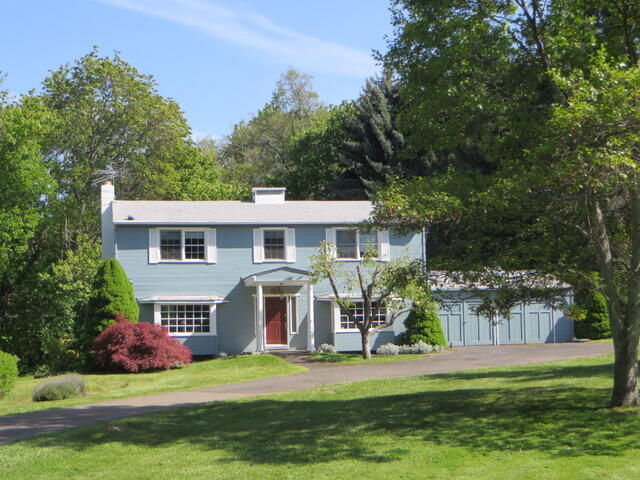 First time on the market! Less than five miles from town, this irrigated rural property offers the best of Ashland in a wonderful country neighborhood. For decades, kids rode bikes in the quiet cul-de-sac, splashed in Neil Creek, and played tag in the wide, grassy yard and pasture of this beloved family home. Now it's your turn to write the next chapter. The sunny, traditional home features large windows, a cozy living room with wood-burning fireplace, and French doors to a big back deck—perfect for family gatherings. Refinished oak floors gleam in the entry and dining room, while a wide traditional staircase welcomes you upstairs to the bedrooms. A large primary has two closets and access to the bathroom. There are another two spacious bedrooms, plus a fourth room that was used as an office but could easily be another bedroom. A two-car garage, barn, and shed complete the package. Solid, welcoming, and ready for your family's story.