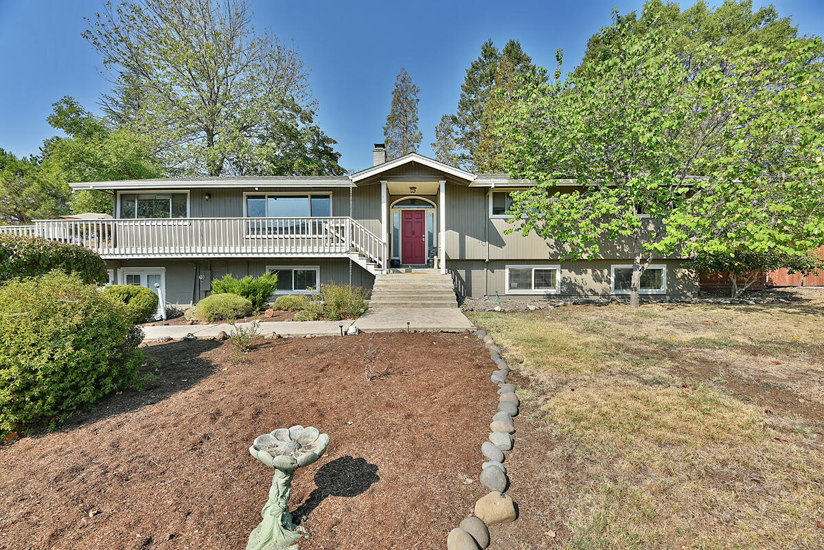Beautiful East Medford home located in Fern Valley Estates. Just minutes from Phoenix and Medford you can have the best of both worlds with a true country feel, but just a short distance from, retail stores, top ranked golf courses and fine dining. This home is surrounded by mature landscaping giving you privacy from both neighbors and traffic. An open concept kitchen has a large island, large amount of storage that flows into a living room featuring vaulted ceilings, hardwood floors, and views of the surrounding hills. The home offers a sunroom that transitions to a large wrap around deck ideal for entertaining. The downstairs features a finished basement with a large bedroom, full bath and bonus room. This space is perfect for a game room, or even a mother-in-law suite with private door access, if you're taking care of family/friends. With an attached 2 car garage and oversized front driveway you will have plenty of room for cars or RV parking, set up your appointment to view now!
