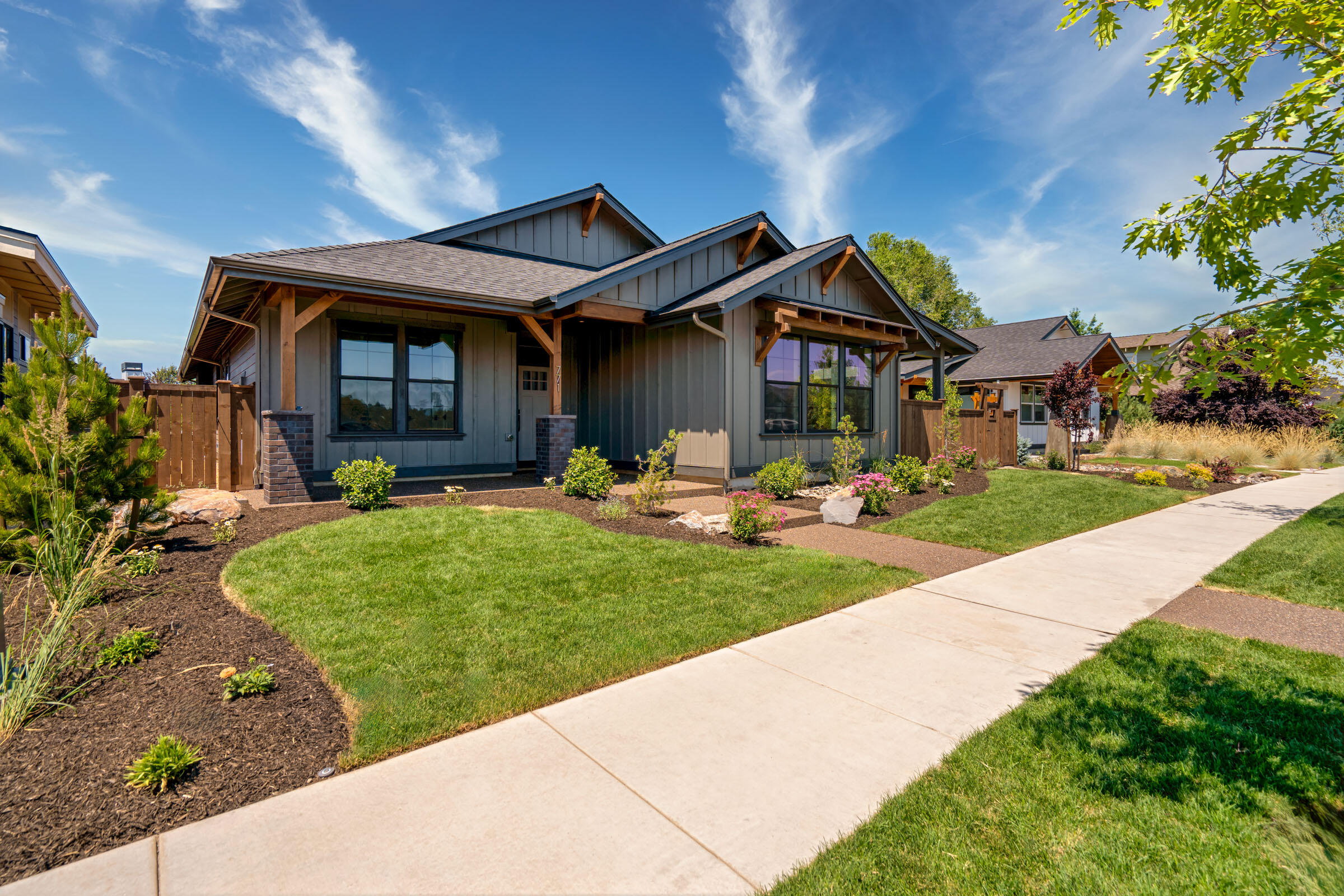 Stunning new construction in sought-after Canyon Rim Village, blending luxury and function in every detail. This 2,094 sq ft single-level home features 4 spacious bedrooms, 2 baths, and designer finishes throughout. The chef's kitchen boasts waterfall quartz island counters, custom hardware, and a curated lighting package. A dramatic floor-to-ceiling brick fireplace anchors the great room. Enjoy two separate fenced yards, including a private patio off the elegant primary suite. The exterior showcases an inviting covered front porch, elegant exposed aggregate, and a 3-car garage with RV bay and 12' door. Truly exceptional!