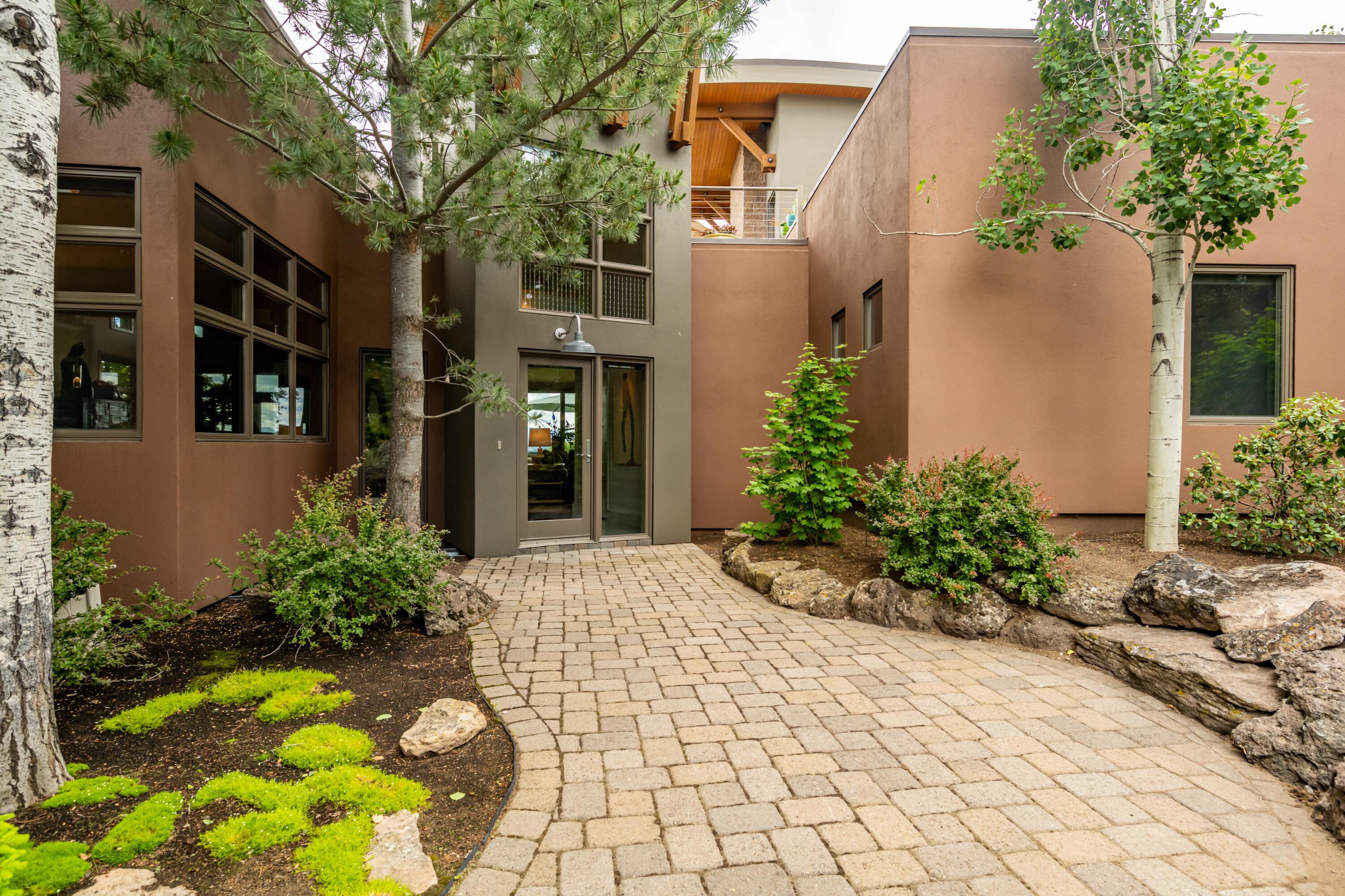 Spectacular panoramic views from this custom contemporary home in NW Bend's Hillside Park. Stunning architecture with attention to detail at every turn is carefully situated on .53 acres to full take advantage of the breathtaking views of downtown, the Old Mill, and the Paulinas. Open great room floor plan features an inviting fireplace with built-ins and stone accents, hardwood floors, and amazing natural light. Gourmet island kitchen is a chef's dream complete with double ovens, stainless steel appliances, slab granite counters, wine refrigerator, and gorgeous dining room. Luxurious main level master suite with private master bath with tile/steam shower, double vanity, & large walk in. Versatile second level bonus room with fireplace and hardwoods leads to the rooftop patio. Don't forget about the workshop in the garage with loft. Outstanding outdoor living at with extensive paver patio, secluded hot tub, plus much more is perfect home for entertaining. This is a truly special home.