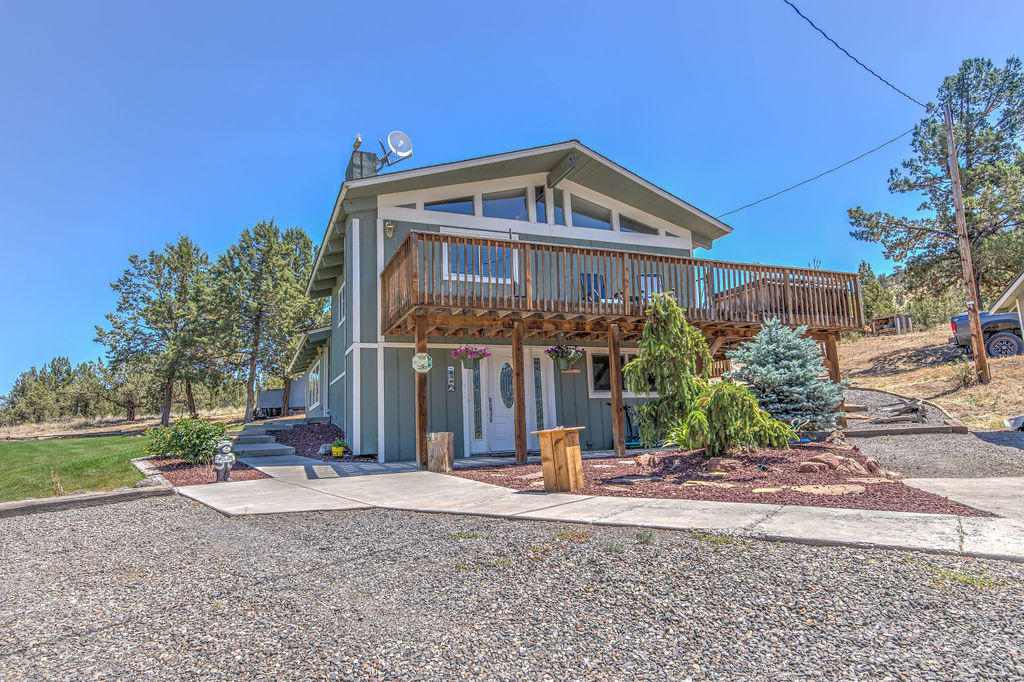 Cute country home on acreage just minutes to town!  Beautiful rimrock and valley views.  3 bedroom 2 bath 1,883 sqft on 1.57 acre.   Large newly sodded lawn gives a wonderful level space to enjoy. Split level ready for your ideas and dreams. Enter to inviting living space with masonry surround wood burning insert with blower.  Home boasts forced air and AC to beat the heat. Two bedrooms up and one additional bedroom and living space on the lower level.  Roof is 2016, Well pump 2009.  Room for RV, nice patio with fire pit out back.  Get a taste of the country life yet still close to town!