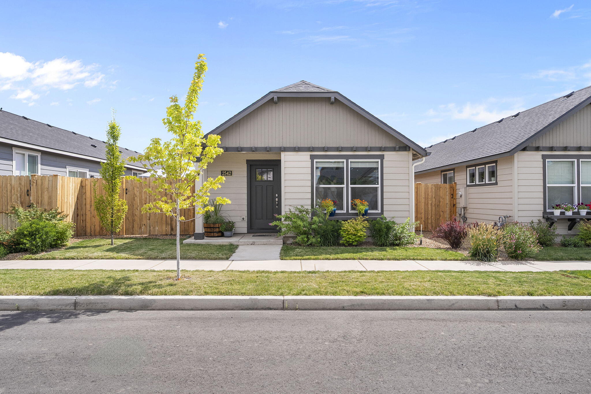 This charming single-level townhome offers a smart, efficient layout with plenty of style. The granite kitchen features generous counter space, a large pantry, and a breakfast bar. The entry leads into a warm and welcoming living area with great flow throughout the home. The primary suite includes a spacious closet and private bath, while two additional bedrooms offer flexibility for guests, a home office, or den. A separate laundry room adds storage and convenience. The attached garage, which includes built-in shelving, is the only shared wall, providing added privacy. Outside, the fully fenced, low-maintenance yard offers a perfect space to relax, garden, or play. A must see!