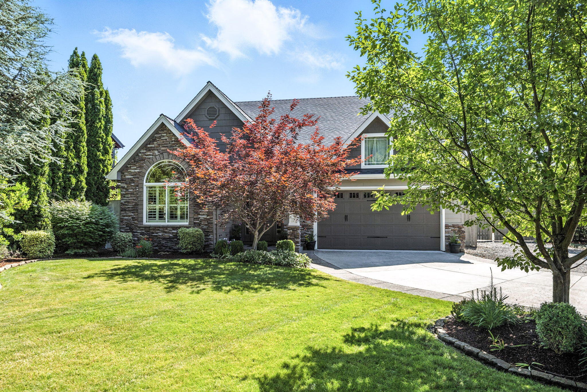 The moment you arrive at this sunny corner lot in Stonegate Estates, you feel it- this is a home that lives well. The spacious dining area draws you in, opening to a large, well-appointed kitchen with abundant counter space and room to gather with ease. The living room offers comfort and warmth with a gas fireplace and soft natural light. The main-level primary suite features backyard views and a slider that opens to the beautifully landscaped yard. Upstairs, a bonus room awaits to become your movie retreat, creative studio, or the most comfortable office you've ever had. Bedrooms are generously sized, with great storage throughout. Outside, a built-in outdoor kitchen and sparkling pool invite you to relax or entertain, with sun and shade just where you want them. Tucked into one of East Medford's most loved neighborhoods—just minutes from shopping, schools, and freeway access. Ease, beauty, and space to live fully.
