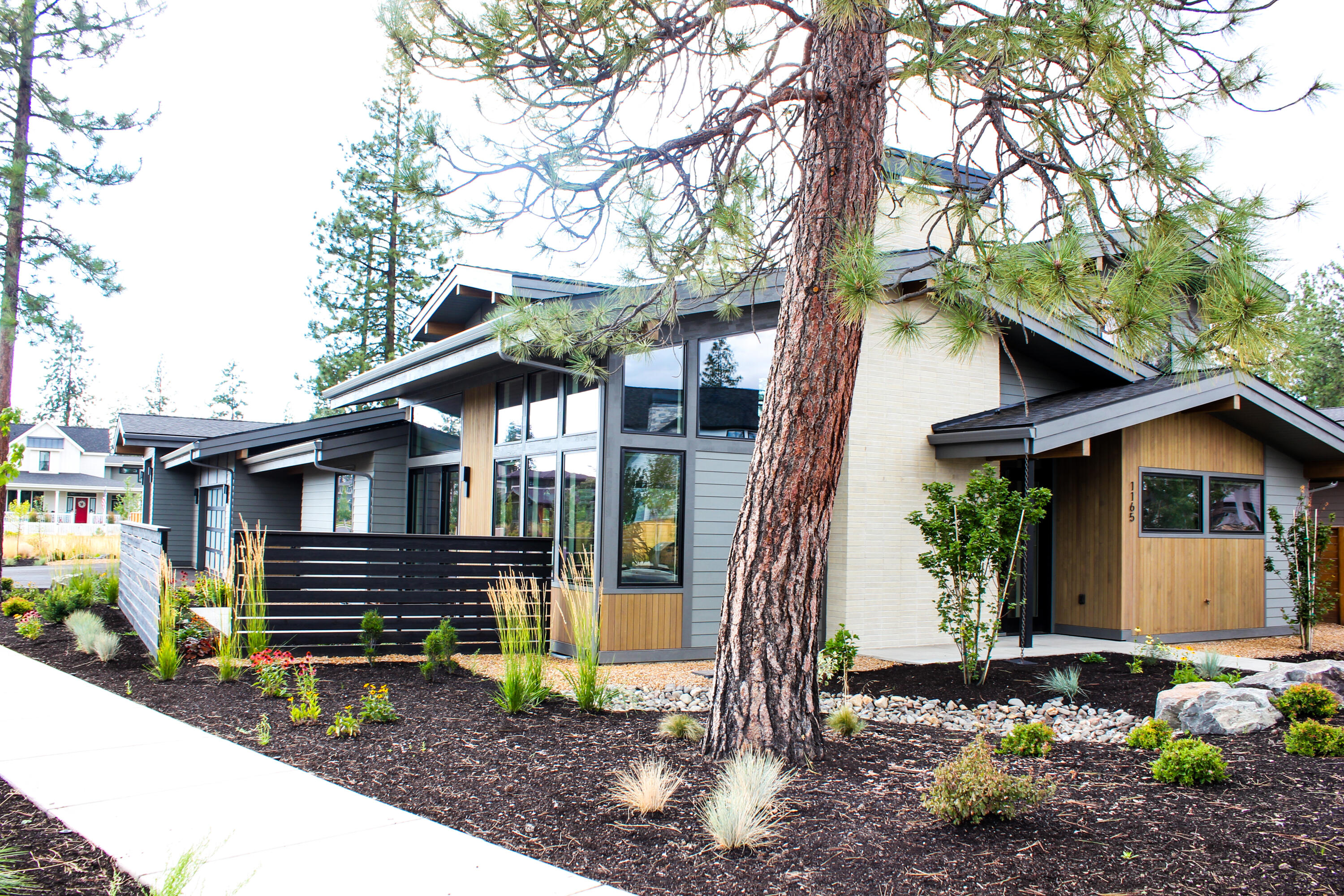 Welcome to this exquisite Mid-Century Modern home designed by local architect Jason Todd & crafted by renowned builder, Michael Wilkins. 
Situated on one of the larger lots in DW and backing up to open space, this home offers direct access to neighborhood trails and is within walking distance to Elementary, Middle, and High Schools.  It features an open concept design, high ceilings, and wood-wrapped Pella windows. The quality is unparalleled with sand-in-place hardwood floors, slab quartz countertops, high-end Thermador appliances, heated master bathroom floors and automated blinds. Truly setting it apart is its massive 3-car garage with Sprinter bay containing pull-through access to the large, flat backyard. Outdoor living is a dream with a gas fire pit, new Arctic hot tub, in-ground trampoline and irrigated garden beds. Constructed with Michael Wilkins' attention to detail and using the highest quality materials, this home is a true gem in West Bend!