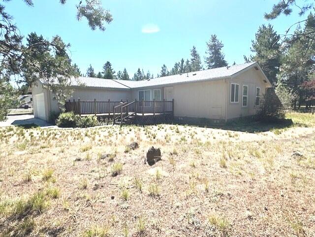 This delightful 3-bedroom, 2-bathroom home offers a perfect blend of comfort and outdoor space, nestled on nearly an acre of land. The attached garage provides convenient parking and storage, while the paved driveway ensures easy access. The back yard has multiple trees, shrubs and flowers.  Enjoy outdoor gatherings or quiet mornings on the spacious deck, ideal for relaxation or entertaining. The fully fenced and gated property enhances privacy and security. Additionally, a storage building offers extra space for tools, equipment, or seasonal items and vehicles. For added peace of mind, the seller has installed a brand-new TTY septic system. This property combines practicality with charm, making it a wonderful place to call home. Homeowners Warranty included with purchase.