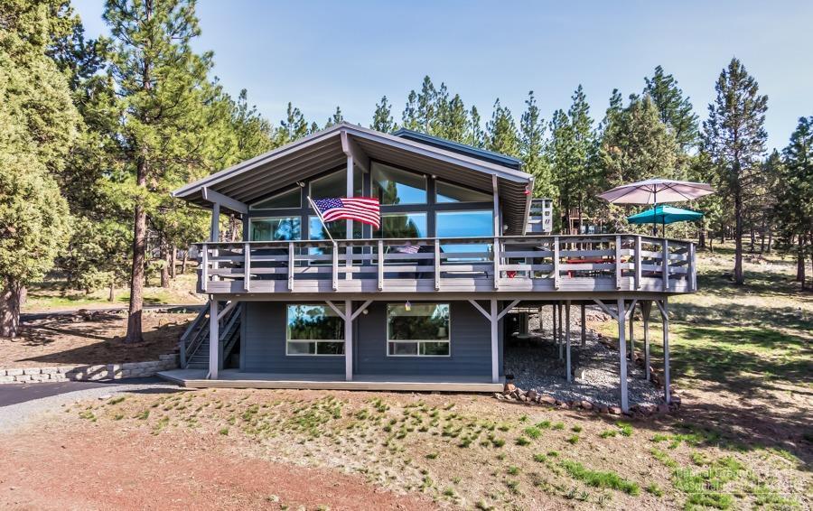 Serenity awaits you under the pine trees. Thoughtfully positioned on 1.27 secluded acres you will find a modern masterpiece. Natural elevation lets you gaze out over the tree tops and enjoy the expansive Cascade Mountain range. Views & natural lighting are captured in nearly every oversized picture window, or from one of your spacious three patio spaces. Recently fully remodeled you will enjoy ship lap accents, 5 burner cook top, wide plank hardwood floors, trendy tile and slab counter tops. Great room floor plan lives large and maximizes its square footage, featuring modern design, and elegant lighting. Oversized two car garage has room for all of your recreational toys, plus dedicated RV parking/hook ups and space for a shop! Featuring the highest quality that is exceptionally maintained and offering private low maintenance living minutes from town, trails, and park systems!