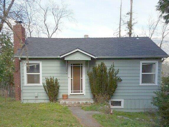 1950 Charming Cottage with beautiful views!!! LOTS of potential for this existing 1 bed, 1 bath, approx. 672 sqft., with beautiful fir floors under carpet, full basement/garage. Corner 0.18 ac. lot which gives a wonderful spacious feeling. Sellers have started the process with the city of Ashland planning department, to expand the footprint of the existing home, plans have not been finalized. Buyers to do their own due diligence with the city. This is a great opportunity!!!