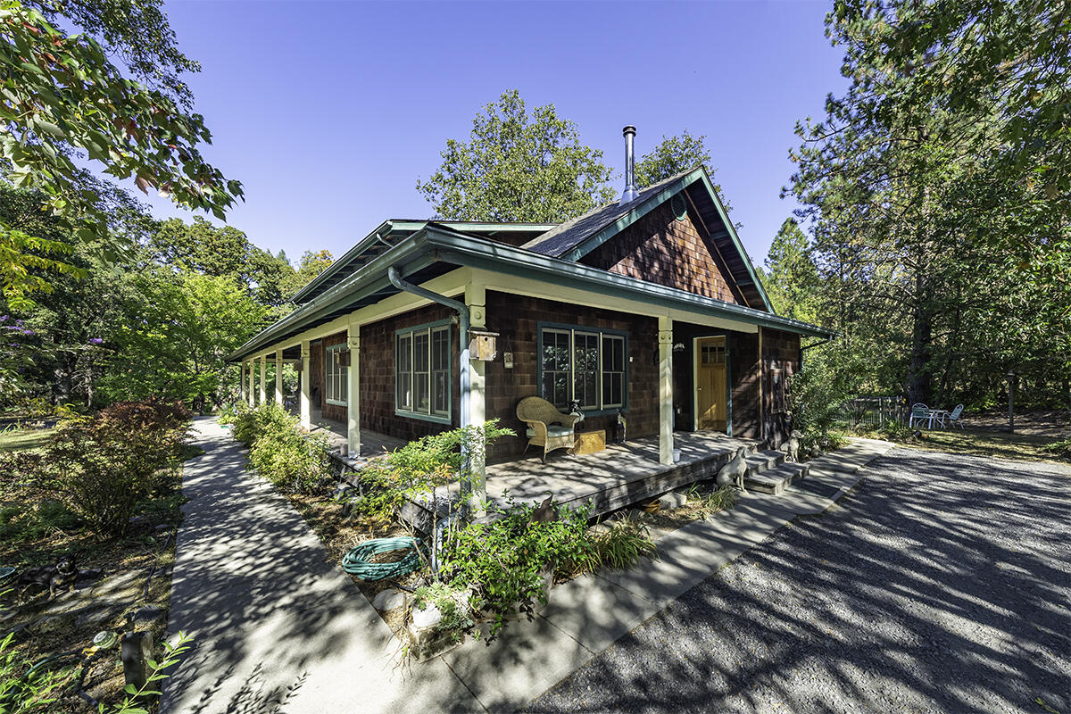 Tucked away from the busy world on 77.63 acres sits this estate with trails & pastures, meadows, 5 ponds, and forest nooks providing ferns, shade trees and evergreens along with creek frontage. Fully equipped with an 8 stall ''Mare Motel'' matted & covered, with cross fencing & runs, as well as a dog kennel.  There's 4560 sq ft barn, with two attached workshops and a spacious studio apartment, a wildlife viewing copula and covered storage for hay and equipment. Near the main house you'll find an oversized detached garage with extra space that can function as an office or art/yoga studio. Enter the inviting 2993 sqft custom built craftsman style home boasting 3 very spacious bedrooms with the Primary Bedroom on the main floor and 2.5 bathrooms. The comfortable study provides tongue and groove wood finishes and built-in shelving. Upstairs you'll find two additional bedrooms, along with two covered decks to view the wildlife, ponds & pastures in all seasons.
