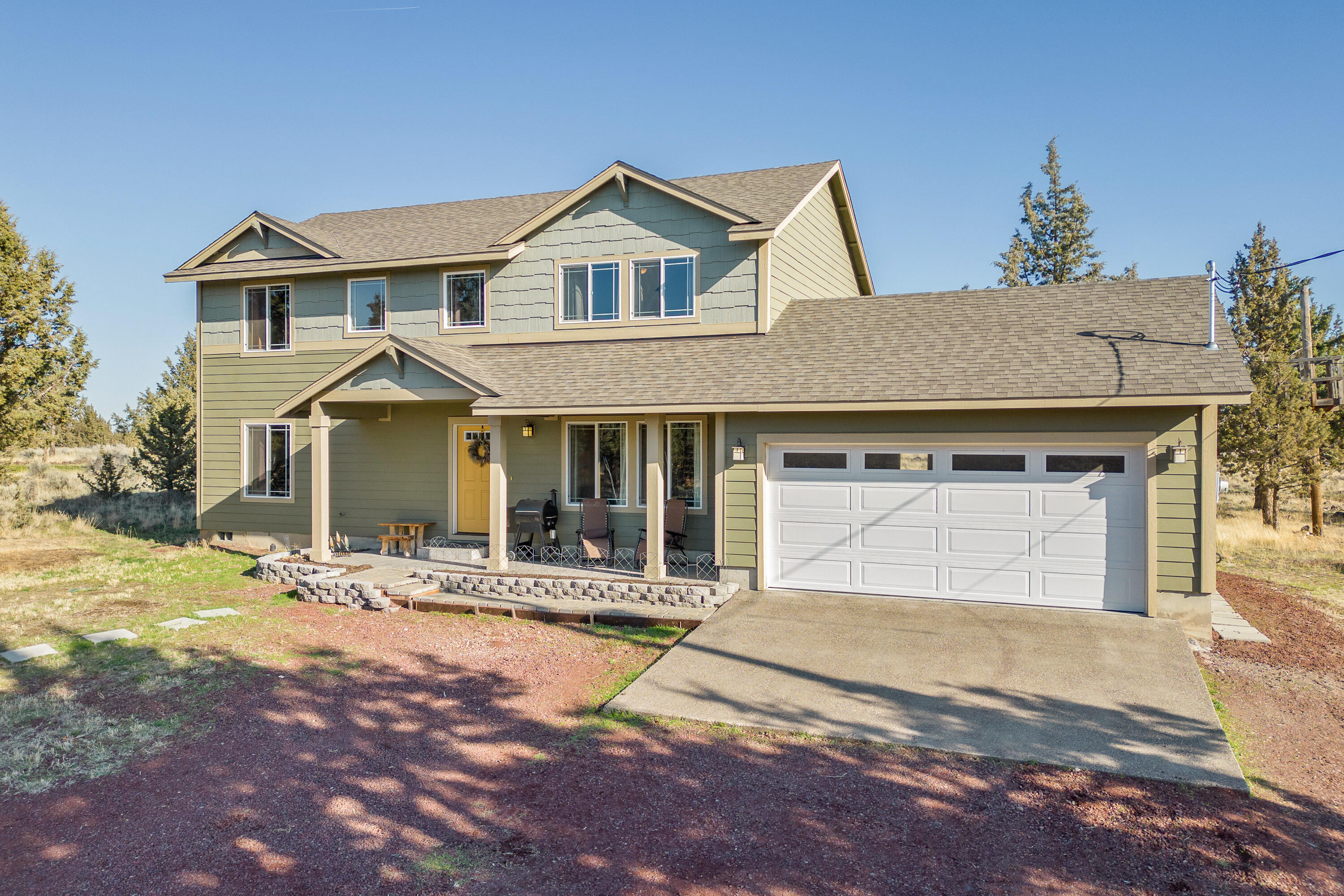 Spacious family home backing to BLM with a large detached shop, Cascade Mountain views, and easy access to trails and all of the great community offerings of the ranch! The home features a welcoming covered front porch, comfortable living, dining, and kitchen spaces with engineered hardwood flooring in the kitchen, lament counters, and Pacific Crest wood cabinets, and primary bedroom and bath with soaking tub and dual sinks on the main floor. Upstairs features a large bonus room with mountain views, laundry, full bathroom, and three spacious bedrooms. There is plenty of parking for toys in the attached two car garage and detached 30 x 40 shop with a 14'' roll up door for RV/boat parking, workbench and loft storage. The property is also set up for animals with an indoor/outdoor pen in the shop, chicken coop, and garden shed.