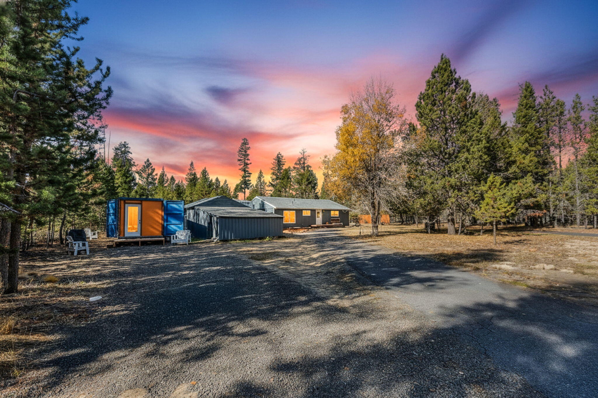 Set on a private one-acre lot, this beautifully renovated single-level home offers the perfect mix of comfort, privacy, & space for all your toys/critters. Open living area is filled w/an abundance of natural light, massive stone-surround wood-burning FP, addtn'l pellet stove, oversized vinyl picture windows, & hardwood floors throughout the main living area. Updated kitchen boasts abundant cabinetry, plenty of counter space, appliances included & an adjacent large dining or flex area perfect for gatherings. Primary bedroom ftrs sliding doors out to the back deck, while the secondary bedroom is well-sized & inviting. Lg bathroom ftrs a step-in tiled shower, soaking tub & dual vanities. Spacious laundry room w/washer & dryer! Outside, enjoy the peaceful, fire wise setting, expansive yard complete w/fire pit & endless possibilities this property provides! 50 amp RV hookup & amenities located on site. Fenced on three sides & borders BLM! Adjacent 1 acre lot + portable ADU also available.