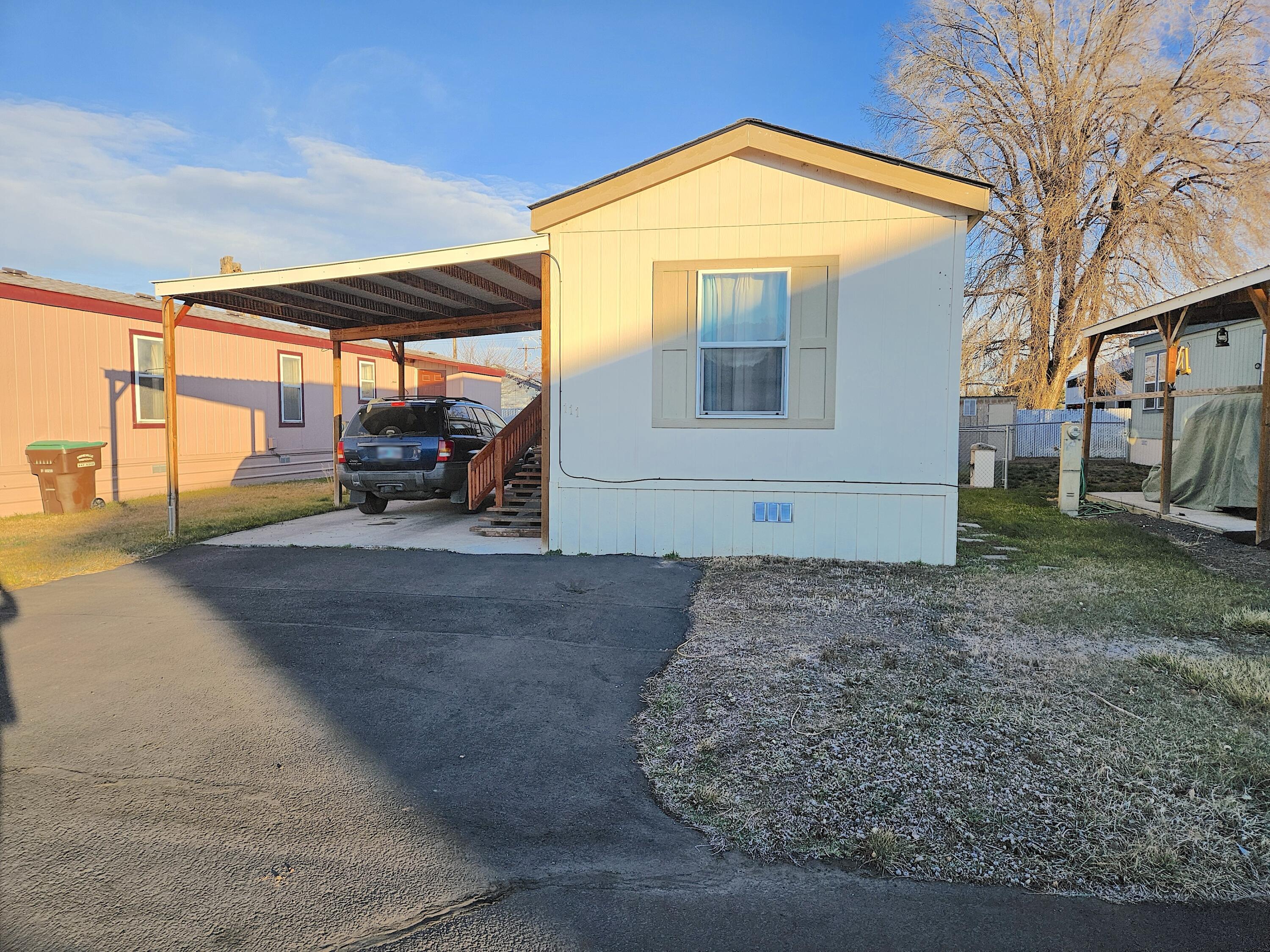 Walking distance to town and the library! Cute and spacious 2 bedroom, 2 bathroom mobile located in desired Queens Garden - 55 and over Mobile Home Park. Kitchen is open to living area with a nice sized island with laundry area close by. Primary bedroom/bathroom on one end of the has 2 closets and a walk-in shower while the second bedroom and guest bath are located at the opposite end of the home. Some nice finishing touches including some crown moulding through out the home. Nice sized fenced yard with 2 sheds and a covered carport. Space rent is $450 a month-inlcudes, water/sewer/garbage.