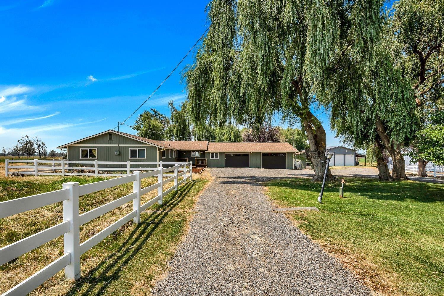 Impeccable four-bedroom home on almost 10 acres (8+ flood irrigated acres), mountain views. Huge kitchen with ample cabinet & counter space, updated baths, expansive living space. Fenced & cross-fenced. Outbuildings include 36X48' shop with 2-12' & 1-14' overhead doors (indoor RV storage) with 2-12' eaves, hay barn, two storage sheds (8X12' & 10X20'). RV parking pad with 30 amp, sewer & domestic water hookups. Enjoy Central Oregon's lifestyle in this home with frequent family & friend gatherings.