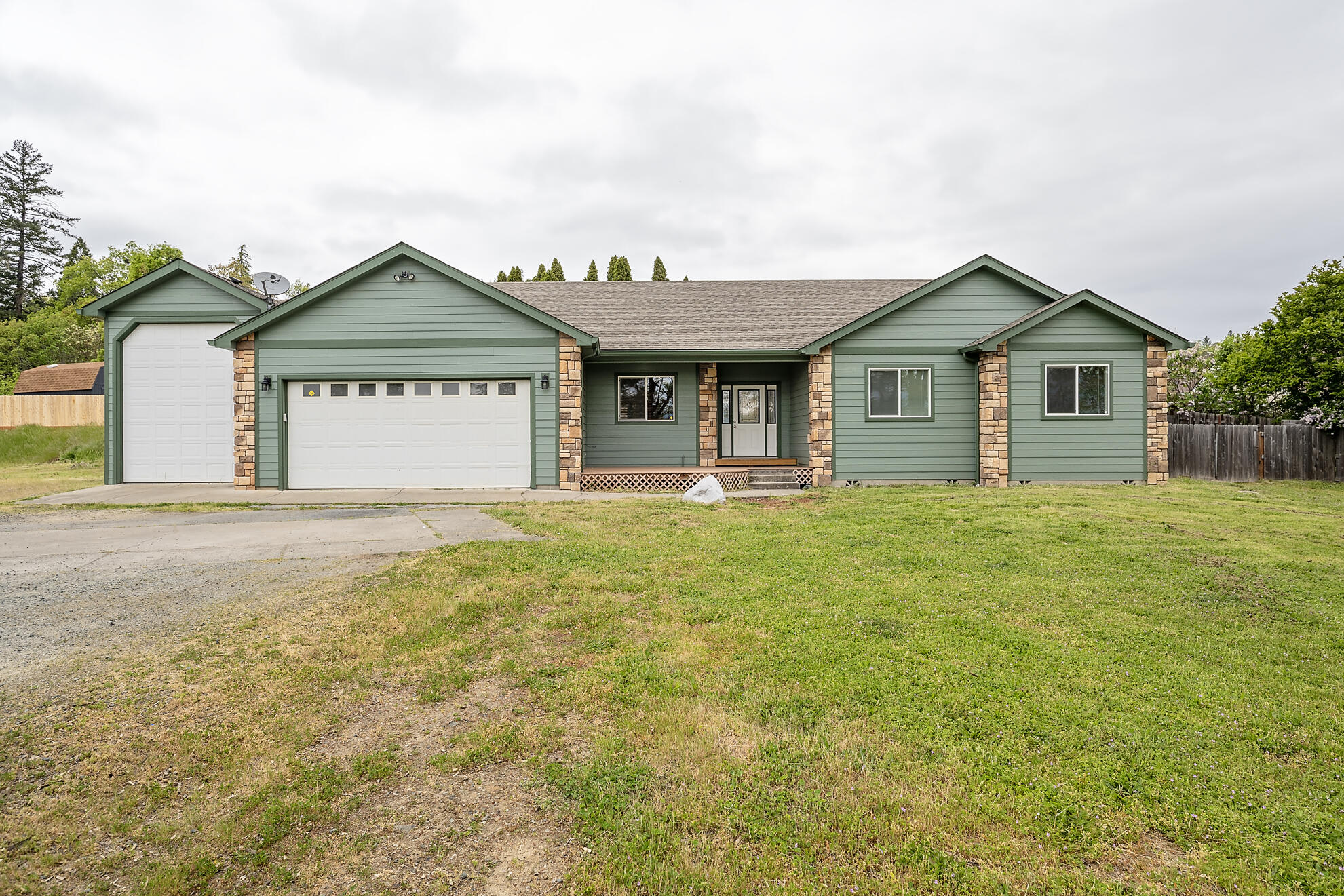 Escape to a relaxing retreat in NW Grants Pass. This stunning 3 bed, 2.5 bath, (plus an office)  single level home is nestled on 1.38 acres close to town with a rural feel! With nearly 1900 sq ft, the open floor plan offers a bright and airy kitchen with alder cabinetry and opens to a covered back patio. The primary suite has a large walk in closet as well as an en suite bathroom with a oversized soaking tub Plenty of room for your toys! Attached garage and 40X16 RV barn with a 12 ft door. Take advantage of the investment potential with this subdividable lot that can accommodate up to 3 additional home sites.