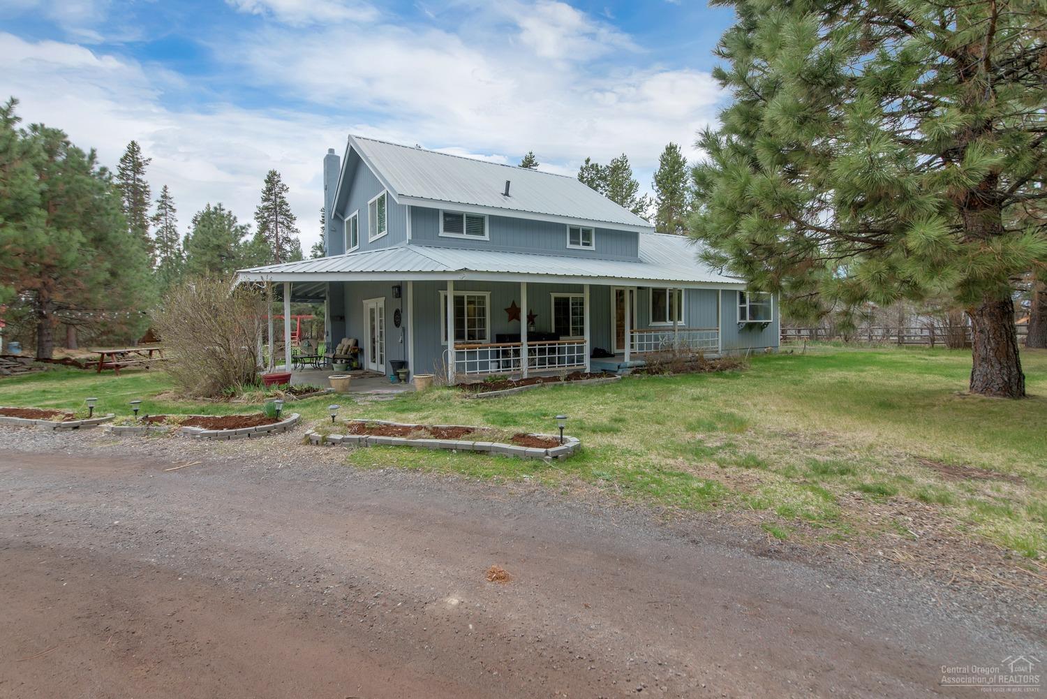 This beautiful 3 bed 2.5 bath home sits on over an acre of land. Large 2 car detached garage, 3 bay covered car port for all your toys. Adjoining public lands. Must see to appreciate.