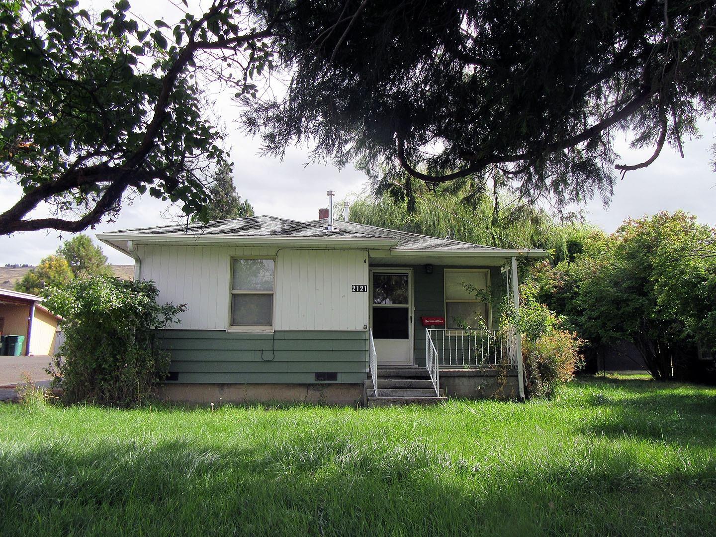 Darling updated 2 bedroom 1 bath home with vinyl windows, metal siding, gas F/A heat, hardwood, tile and vinyl plank floors. Bathroom and oak kitchen remodeled, with appliances. All on .52 acre, with a 2 car carport, 2 storage buildings, fenced area for dogs, Very nice starter home or great rental.
