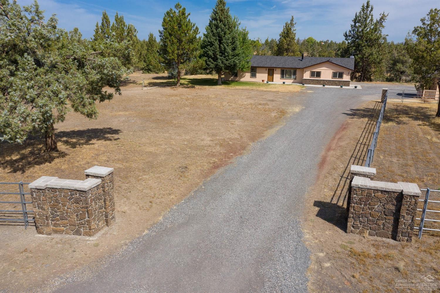 Immaculate updated single level home on an amazing parcel with elevated views of the property. Enjoy the Lodge feel of this spacious home. Rock wall & Wood Accents in the Living & Dining area are beautifully done. Freshly painted inside and out. Kitchen remodeled and updated New Ceramic Tile Counters and SS Sink. New Side by Side SS Refrigerator. Smooth Cooktop and SS Wall Oven. New Carpets and Pad. New Fiberglass Entry Door. New Tiled Shower & Vanity in Master Bath. Lopi Woodstove in LR. Skylight in Hall Bath. Office with Built-ins, Family Room & Bonus Room. Large Utility room w/sink. Studio/Shed is 304sf with built in shelving. New Septic tank. 1/2 interest in a good well. New Hi-Efficiency Mini Split Heatpump. Beautiful Stone and pipe fencing across the front and entry provide amazing curb appeal. 2 level property with road for access to the lower area. Shed barn with hay storage. Perimeter mostly fenced for horses. Seller will consider financing into the sale a shop or barn.