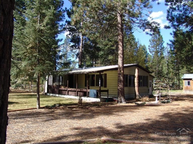 Looking for a move in ready, and an affordable home? This is it! 2 bed 2 bath 1056 sq ft Manufactured Home on 0.78 Acres + or -! Close to town, but feels private! Home Includes an attached Covered family room, Appox 654 sq ft stick built garage with 2 work tables, a 10x29 Storage Building/Hobbie/Craft Room, Extra Large Cedar Wood Storage Building, Covered ATV, Snow Mobile or Boat Storage Area and much more! Beautiful Mature trees! Come take a look today!