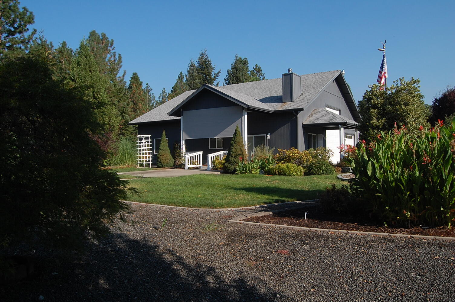Private setting on 1.75 acres, beautifully landscaped, fruit trees, evergreens, and more.  Laminated flooring throughout most of the home, carpet in the bedrooms and bonus room, wood burning fireplace in the living room and propane stove in the family room, the kitchen has beautiful cabinetry and counter tops, the appliances look like new, large dining room, huge family room (was the garage/RV garage), laundry room/half bath-the dryer connection can be electric or connect to propane (tank is not there). There is also an all house fan upstairs in the bonus room area.  RV garage is insulated and has storage area in the back, plus lots of area to park just about anything, there is also 2 large & 1 smaller storage sheds.