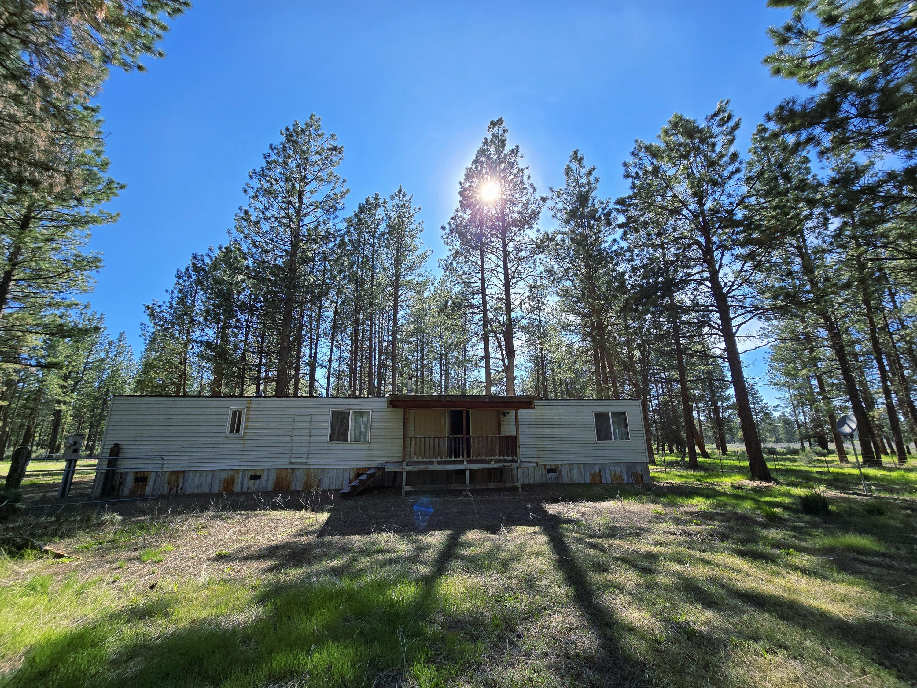 This charming two-bedroom, one-bath mobile home on  Sprague River  in Sprague River, Oregon, offers a serene retreat on 19.84 acres of fenced land. Zoned EFU-CG, the property features outbuildings and a designated garden area, perfect for cultivating your green thumb. The natural flowers and abundant light enhance the property's beauty, providing a peaceful atmosphere.

Sprague River is a delightful small town known for its stunning landscapes and friendly community. Surrounded by nature, it's an ideal spot for outdoor enthusiasts. The property is conveniently located near Klamath Falls, just a short drive away, offering access to amenities and services. Other nearby towns provide additional charm and attractions, making this location perfect for those seeking a blend of tranquility and community. Whether enjoying the expansive outdoor space or exploring the vibrant surrounding towns, this property is a wonderful opportunity for a serene lifestyle in Oregon.