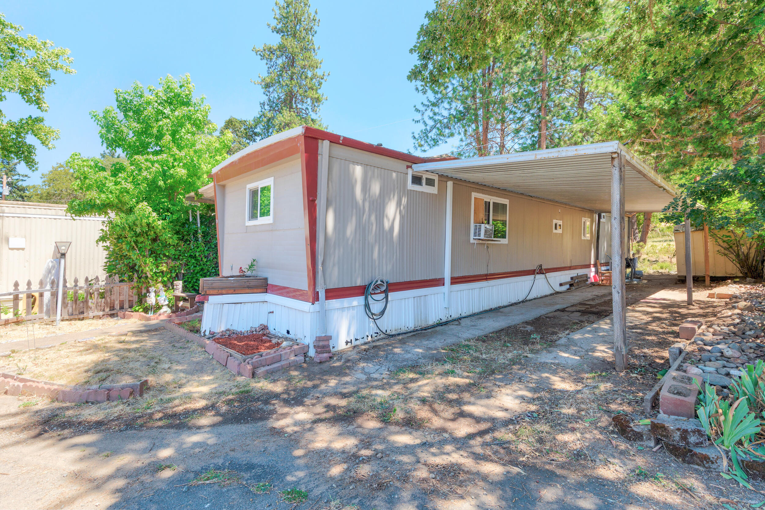 Beautiful mountain views from the back and front of this solid 3-bedroom 1.5-bath mobile in all-ages and pet-friendly mobile park. Newer Daikin ductless heat/air installed fall 2024.  Newer laminate dark wood-like floor could make a comfortable home. Rainfall shower head and beautiful circular vessel basin adorn the main bath. Added laundry room and work room. Seller states mobile park is quite and safe. Come see.